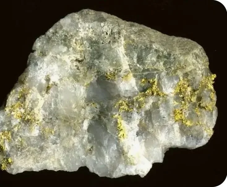 A rough, whitish mineral specimen with small yellowish mineral deposits on its surface.