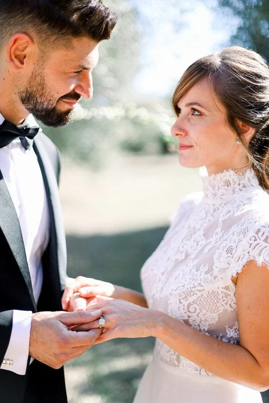 Close up of ring exchange during wedding ceremony at French château