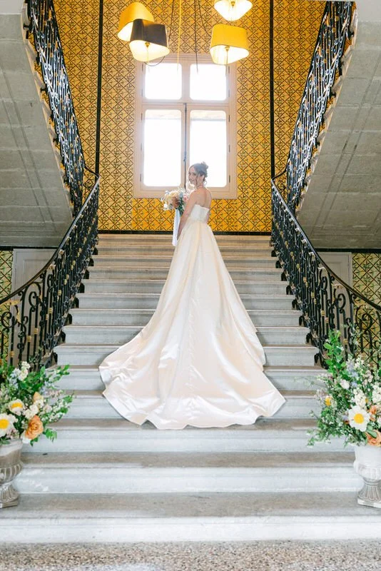 bride posing in the stairs inside the chateau de seriege