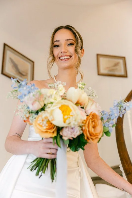 bride smiling with a bouquet 