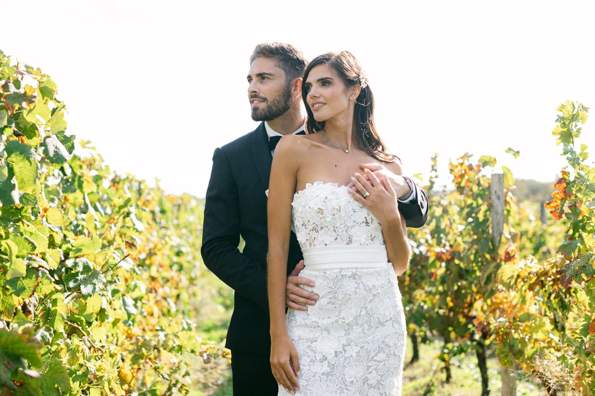 couple posing in the vineyards