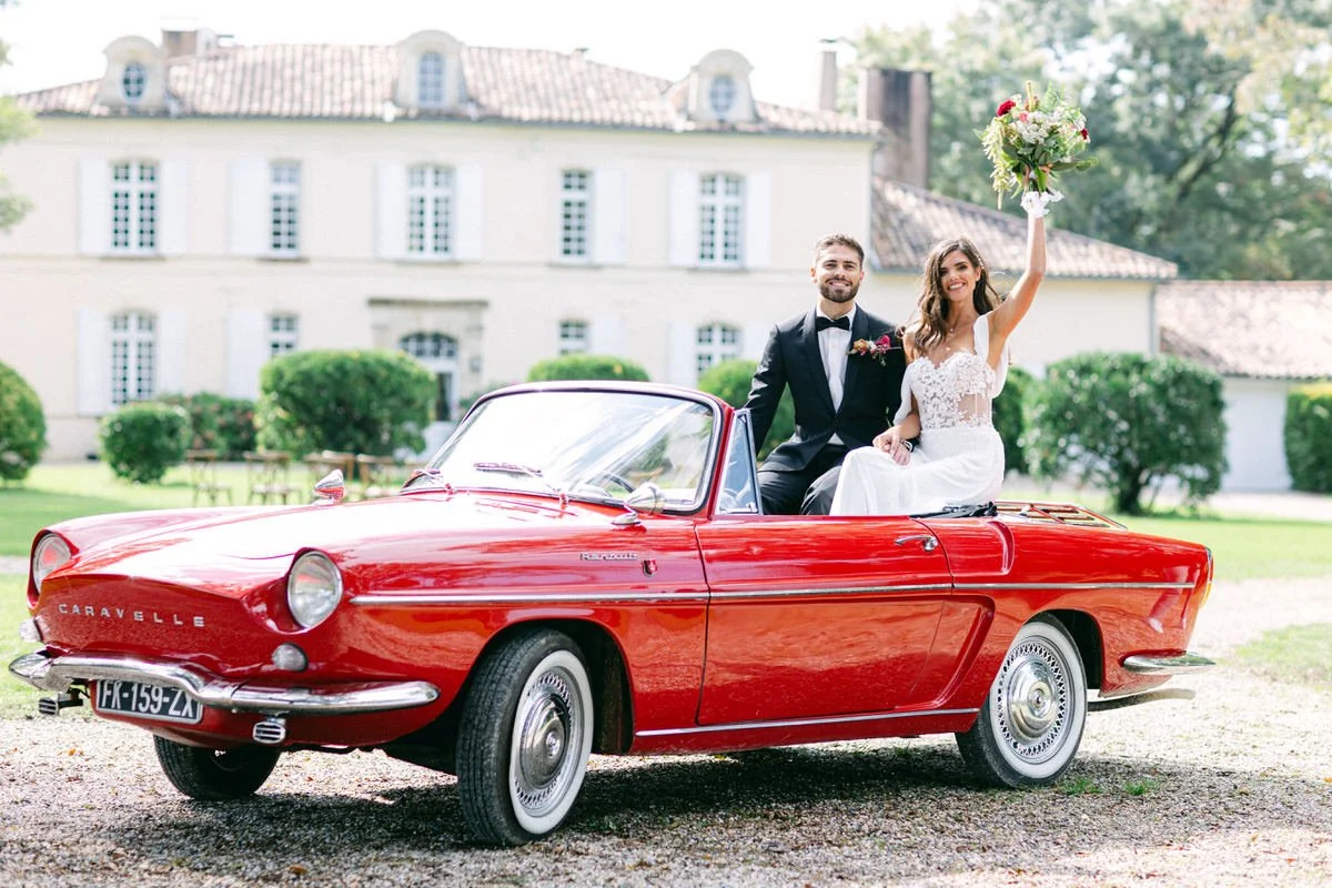 bride and groom sitted on a vintage car