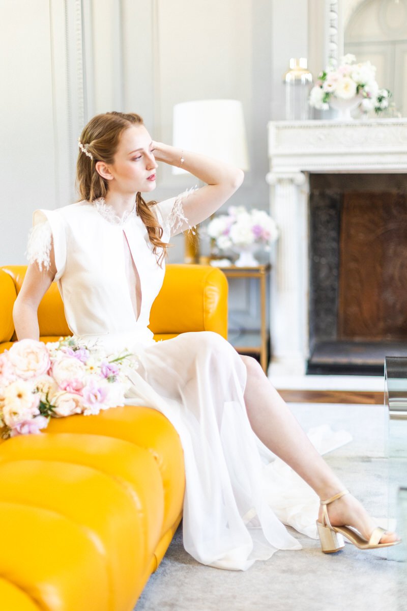 elegant bride on a sofa in chateau de l'hospital