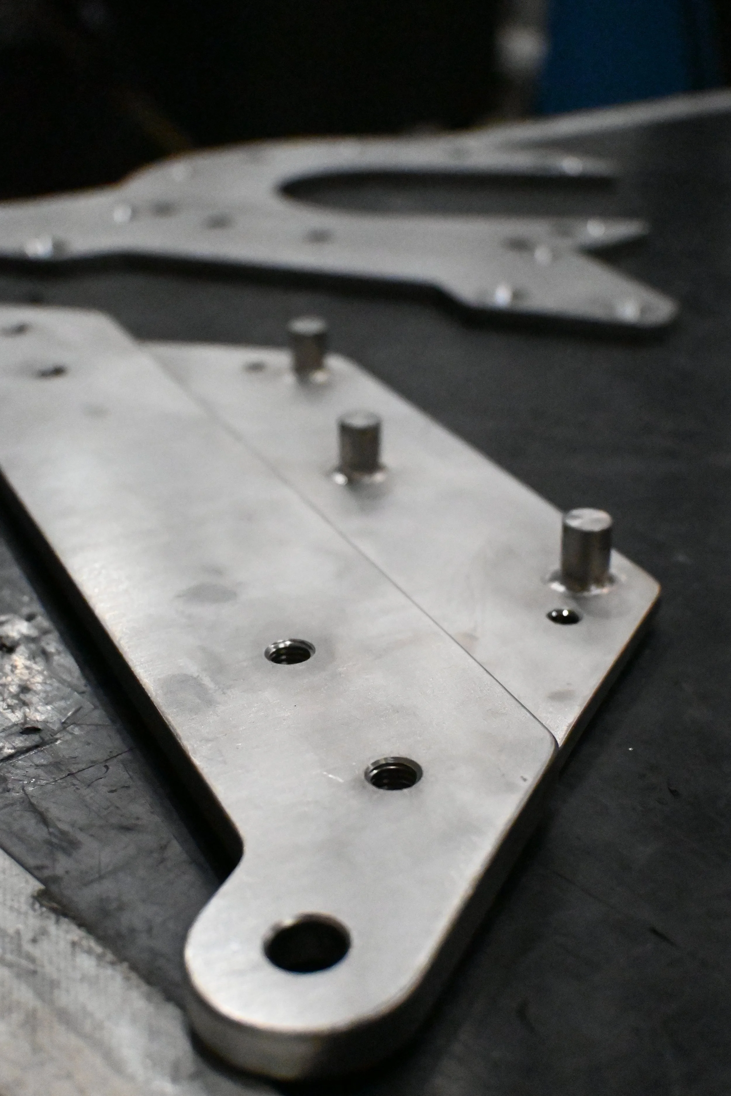 Close-up of a metallic plate on a black surface.