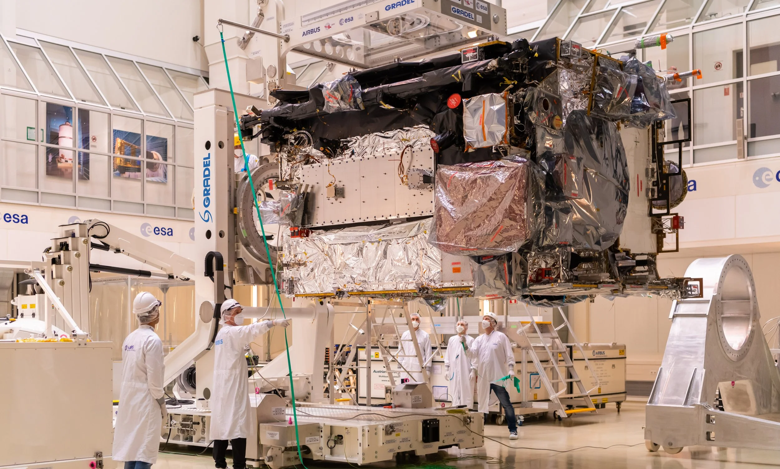JUICE ESA Mission Scientists working on a satellite inside a cleanroom facility with technical equipment