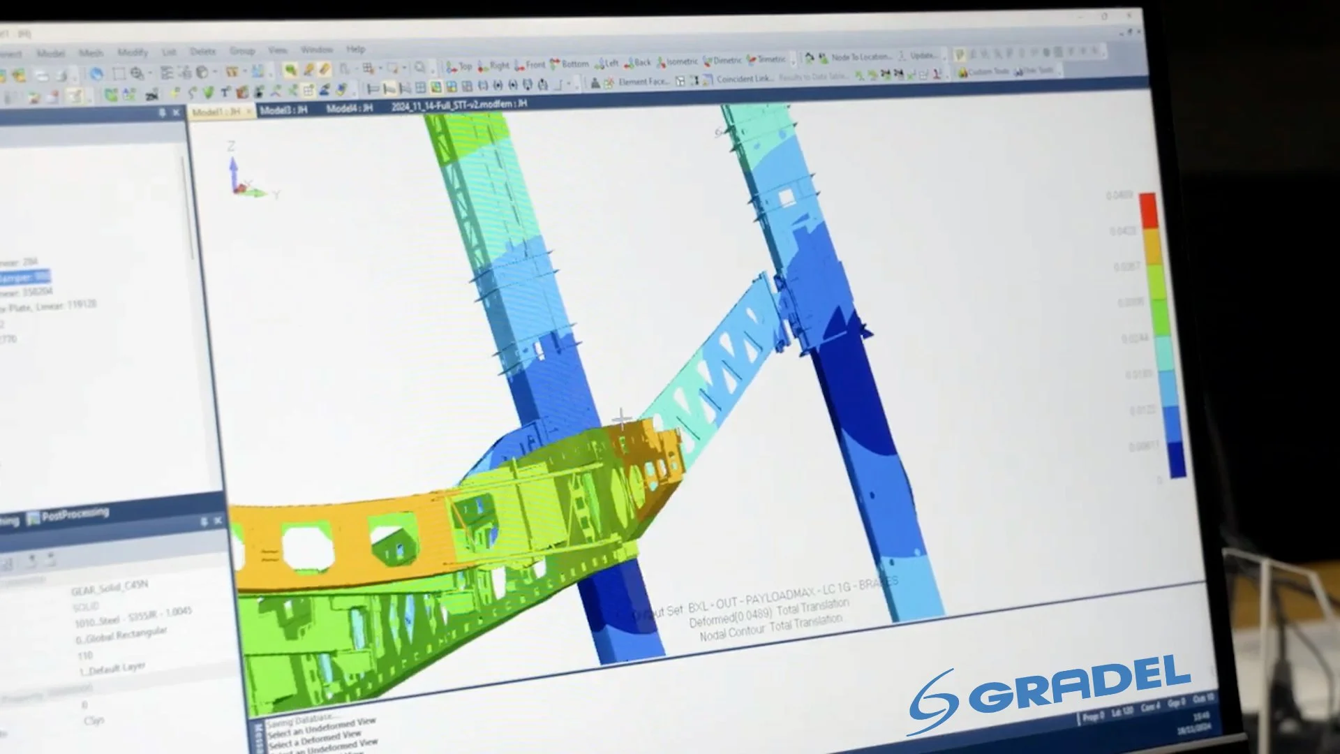 Computer screen displaying a 3D structural model with color-coded stress analysis, with Gradel logo at the bottom right corner.