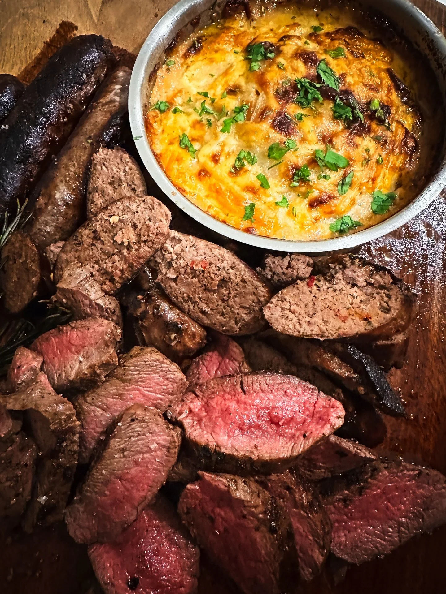 If I could cook one forest meal for someone that would blow their socks off it would have to be this one.

Deliciously smoky venison back straps cooked medium rare. Venison sausages and my signature side of Dauphinoise potatoes. Those thin slices of 