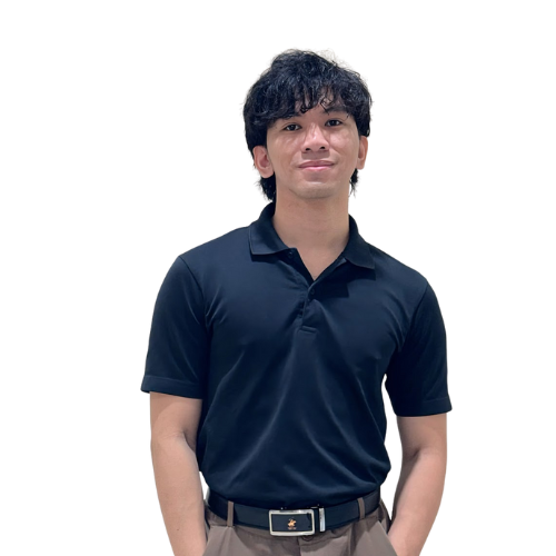 A young man in a navy blue polo shirt and khaki pants, standing with arms relaxed at his sides, in front of a colorful background.