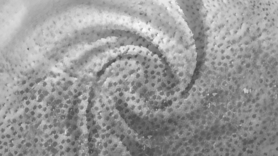 Close-up of a textured, spotted surface with a spiral pattern, possibly a fabric or foam material.