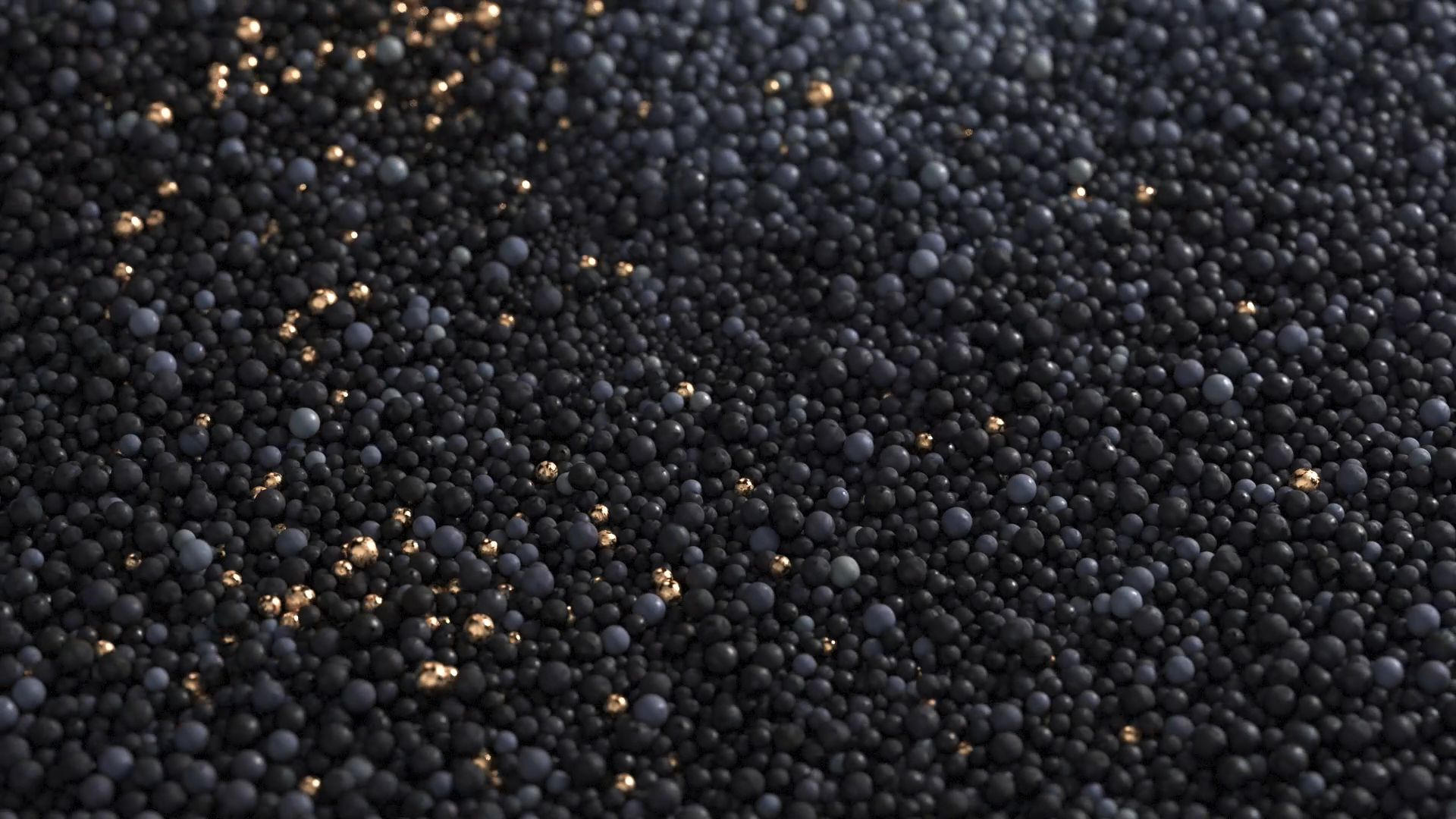 Close-up of numerous small black beads with some gold beads scattered among them.