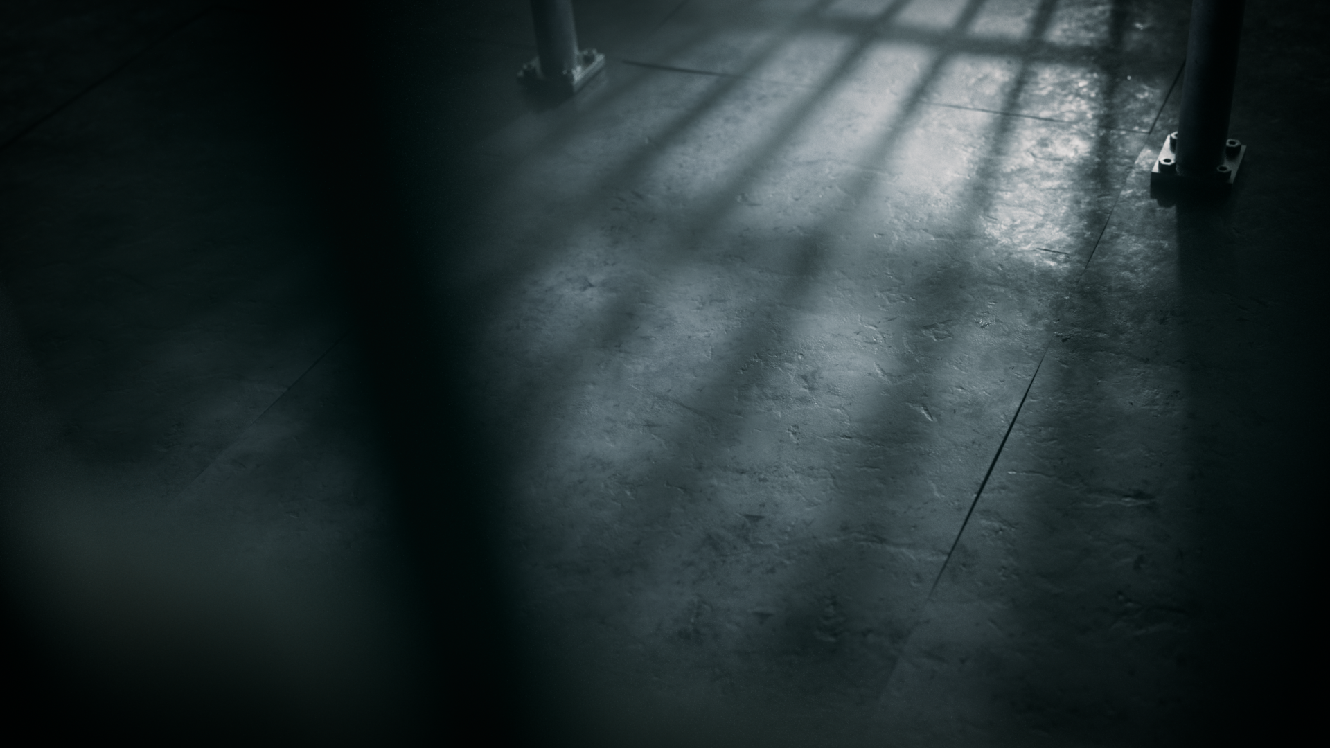 Dark tiled floor with shadows cast by window blinds and a metal table or chair leg
