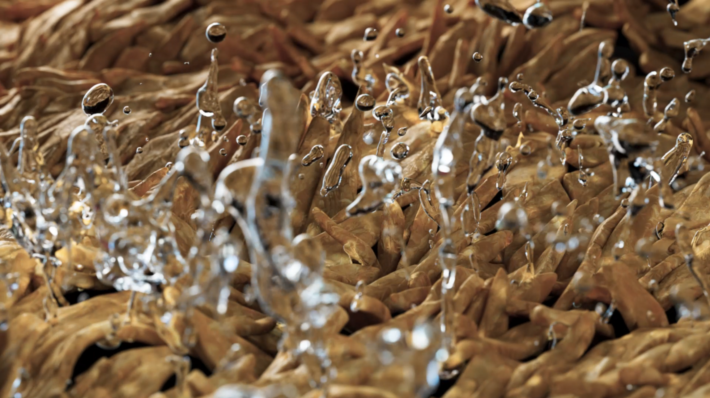 Close-up of a clothes dryer drum with water droplets on the textured surface.