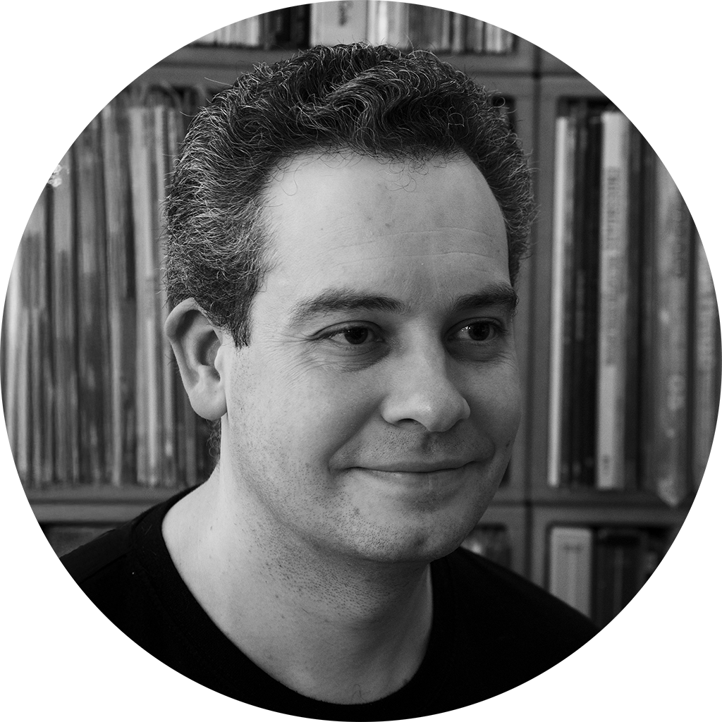 A photo of Jason Ford in front of an extensive vinyl record collection.