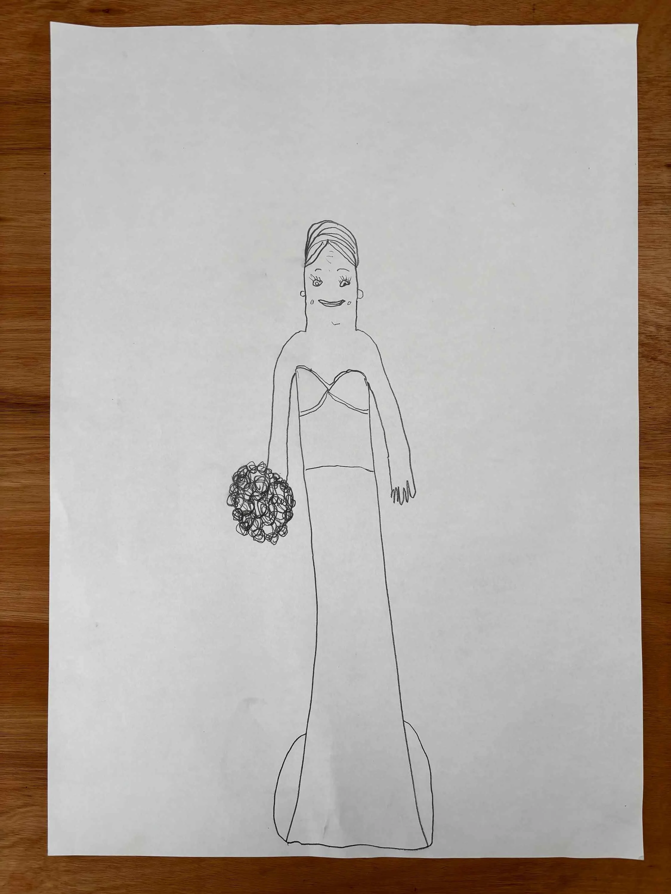 Hand-drawn picture of a person with long hair, smiling, wearing earrings, holding a bouquet of flowers, and dressed in a strapless top or dress.