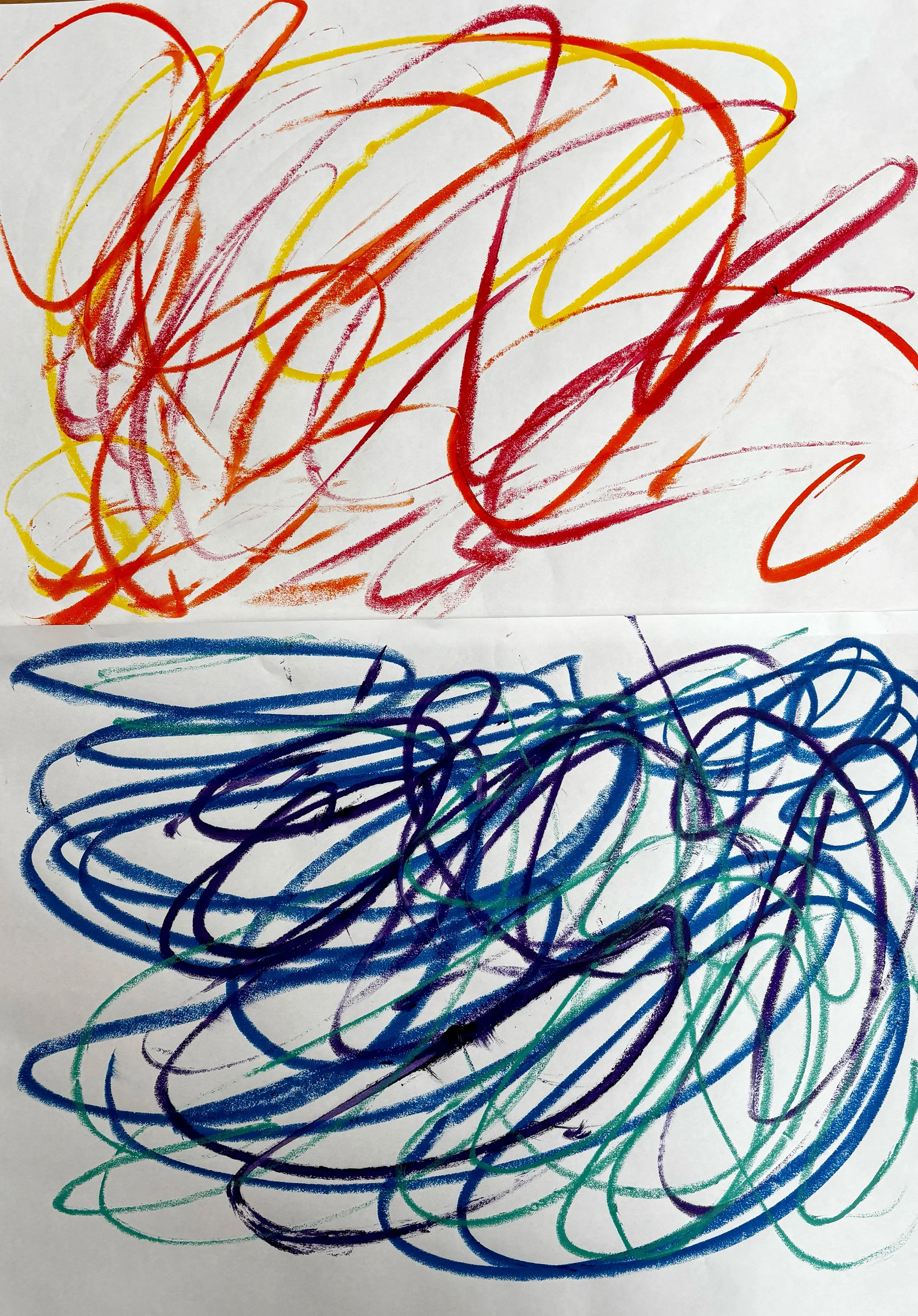 Colorful scribbles on white paper, primarily red, yellow, blue, purple, and green, overlapping and swirling in a playful, abstract manner.