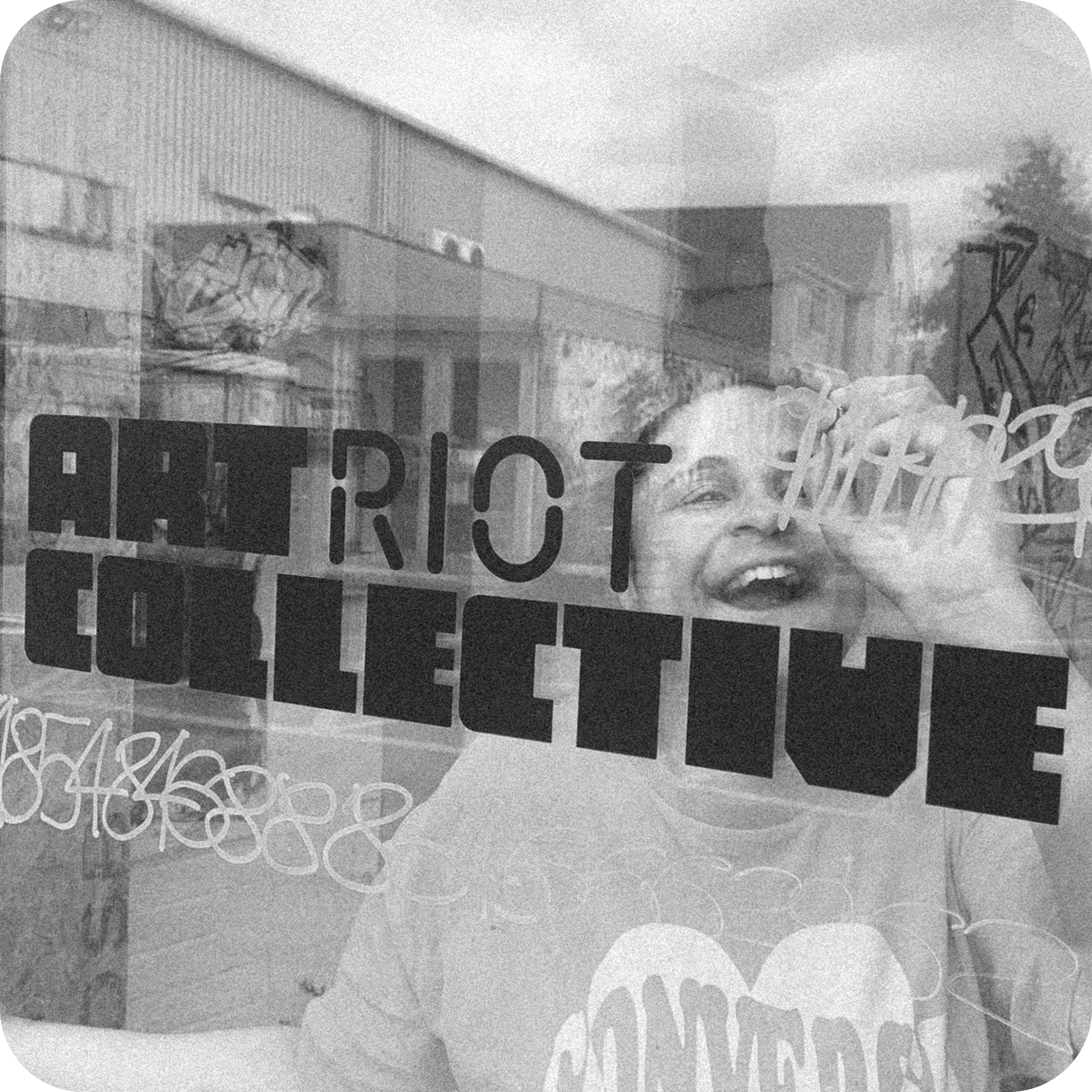 Close-up of a sticker or label with text that reads 'Protest' or similar, partly obscured, with a rough background texture and some graffiti or markings nearby.