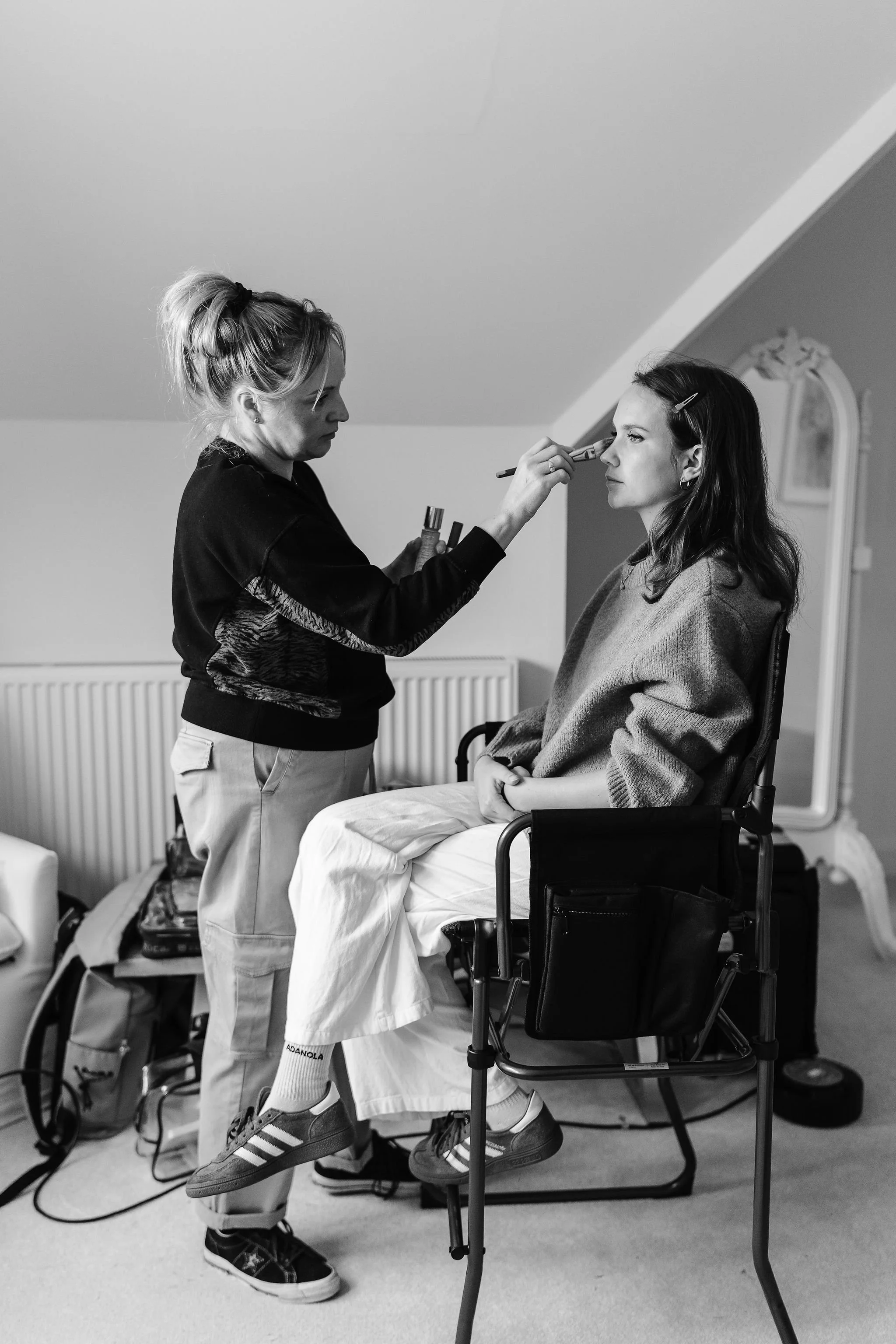 Melissa applying her makeup artistry skills to bride in preparation to her big wedding day