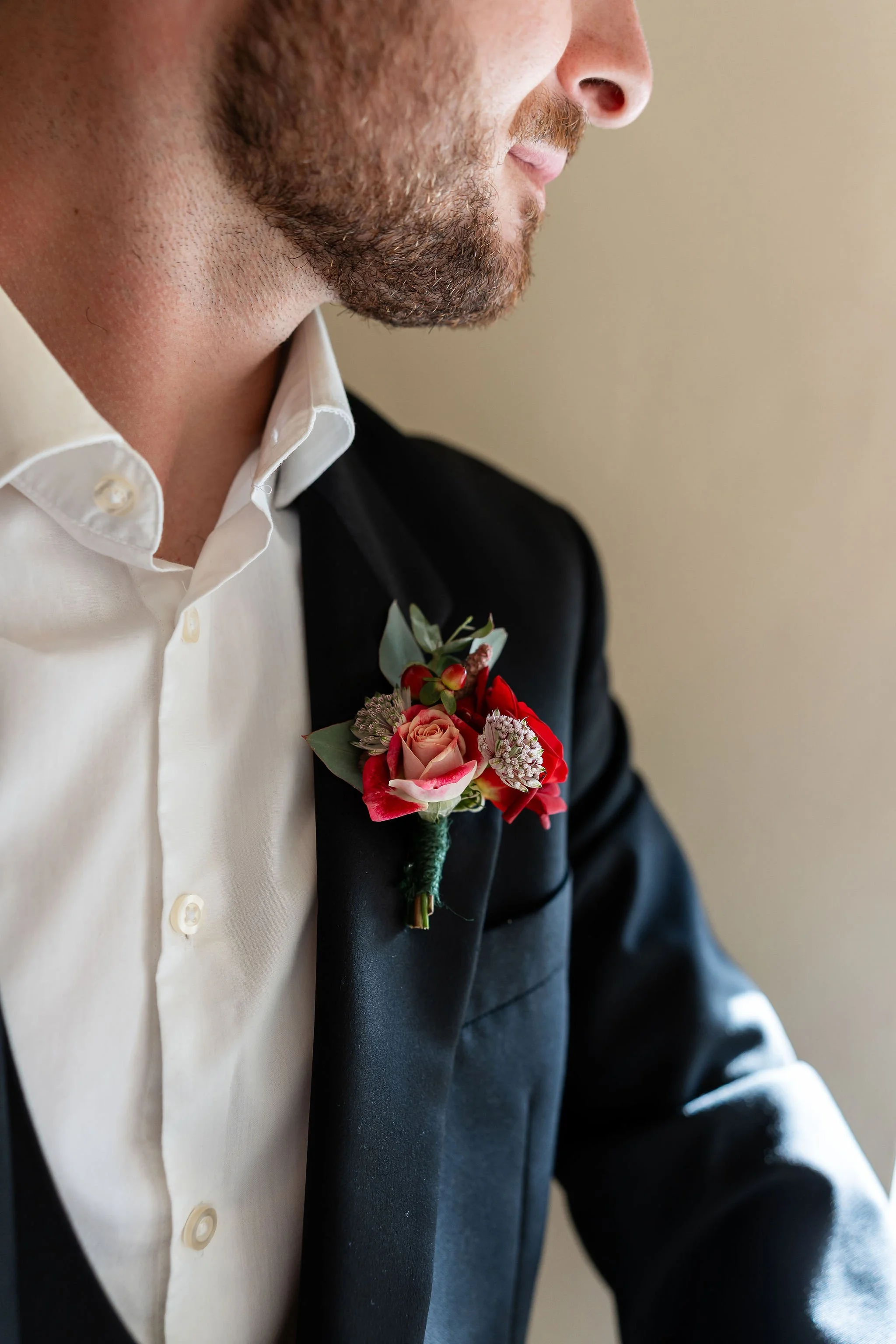 Close up of Groom in a Pure Suit hire complete with rose pin