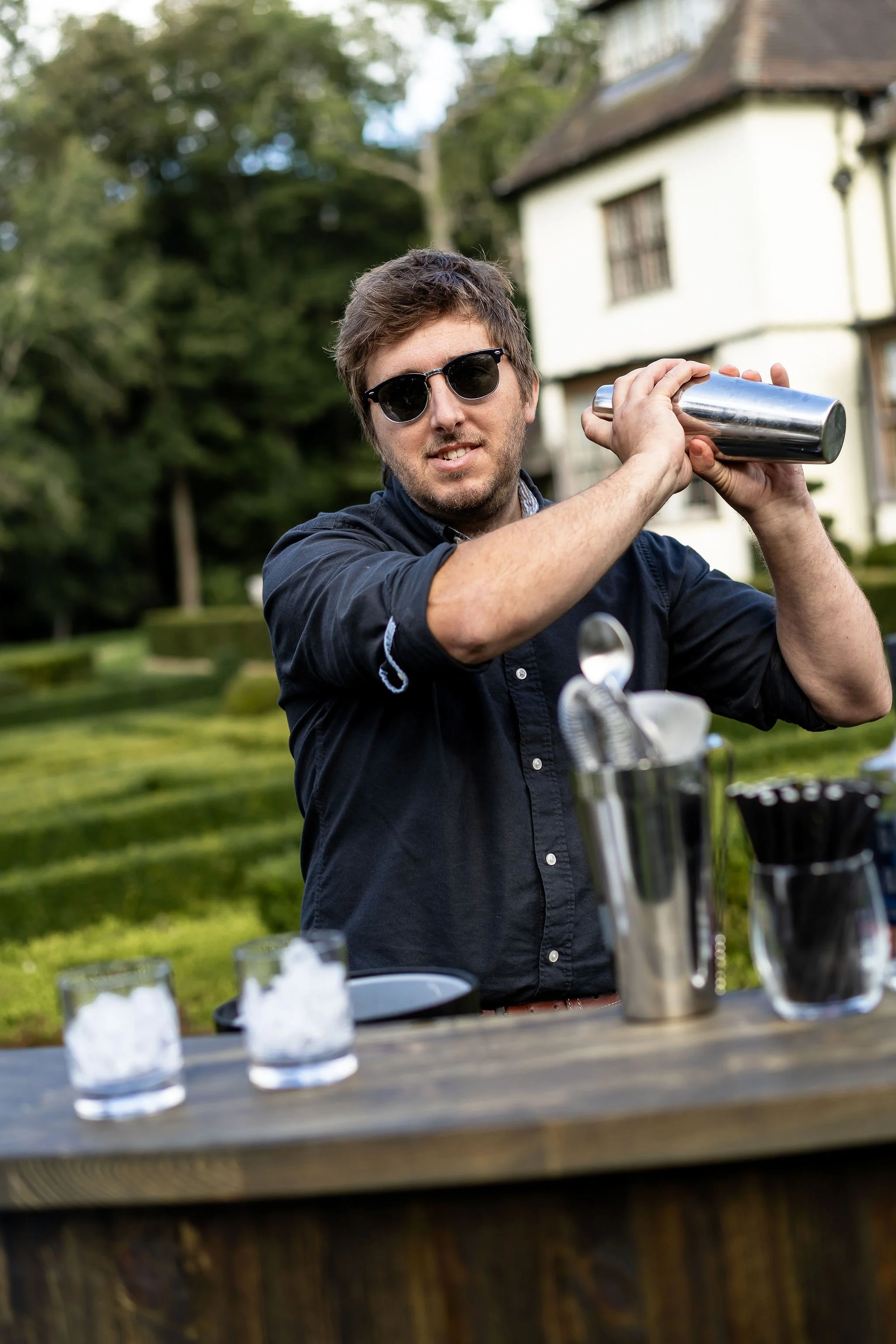 Matty at BEST At BARS mixing up a cocktail outside in the grounds at Little Massingham Manor