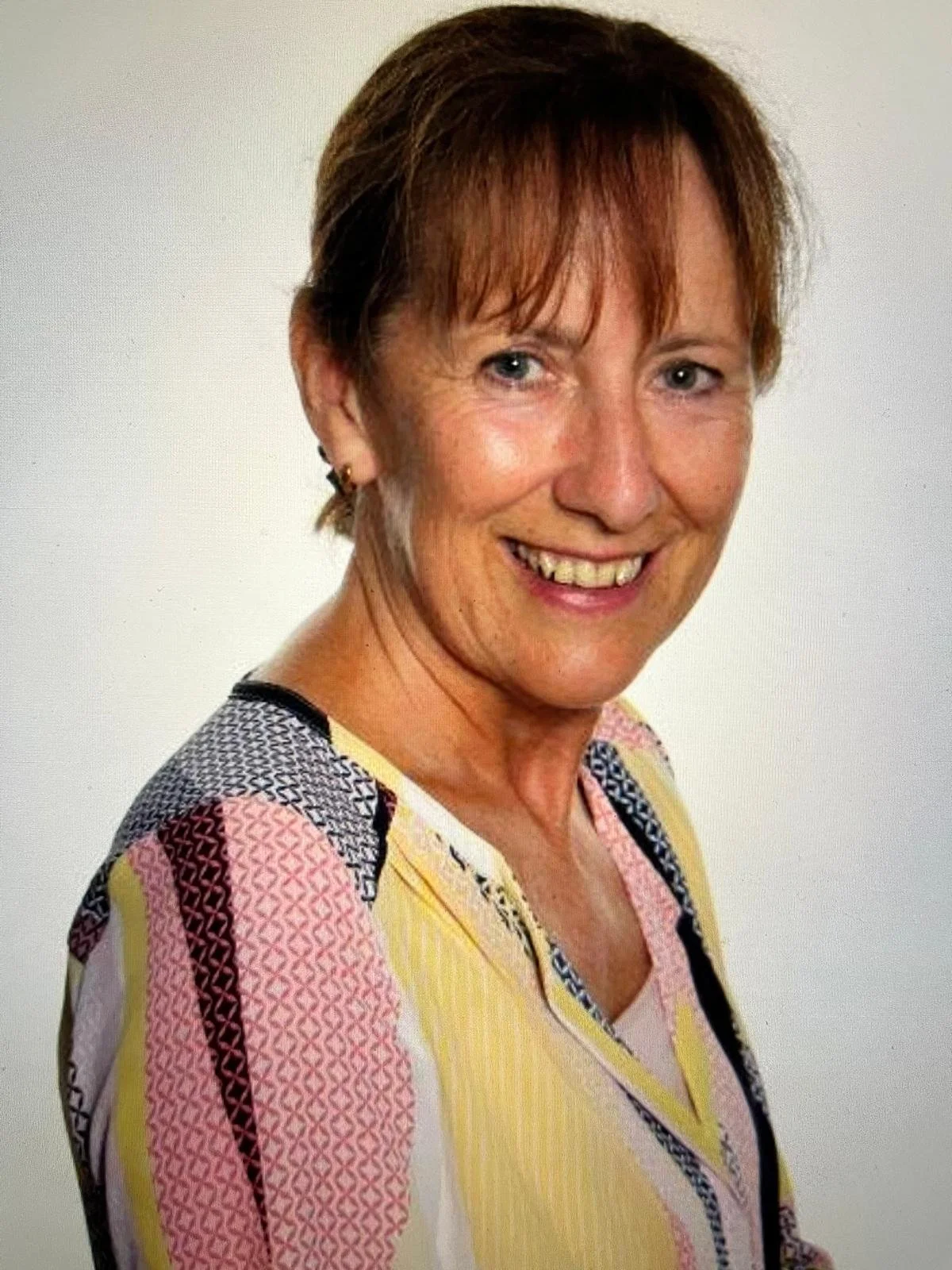 Head and shoulders of Ann Donoghue standing against a white background.