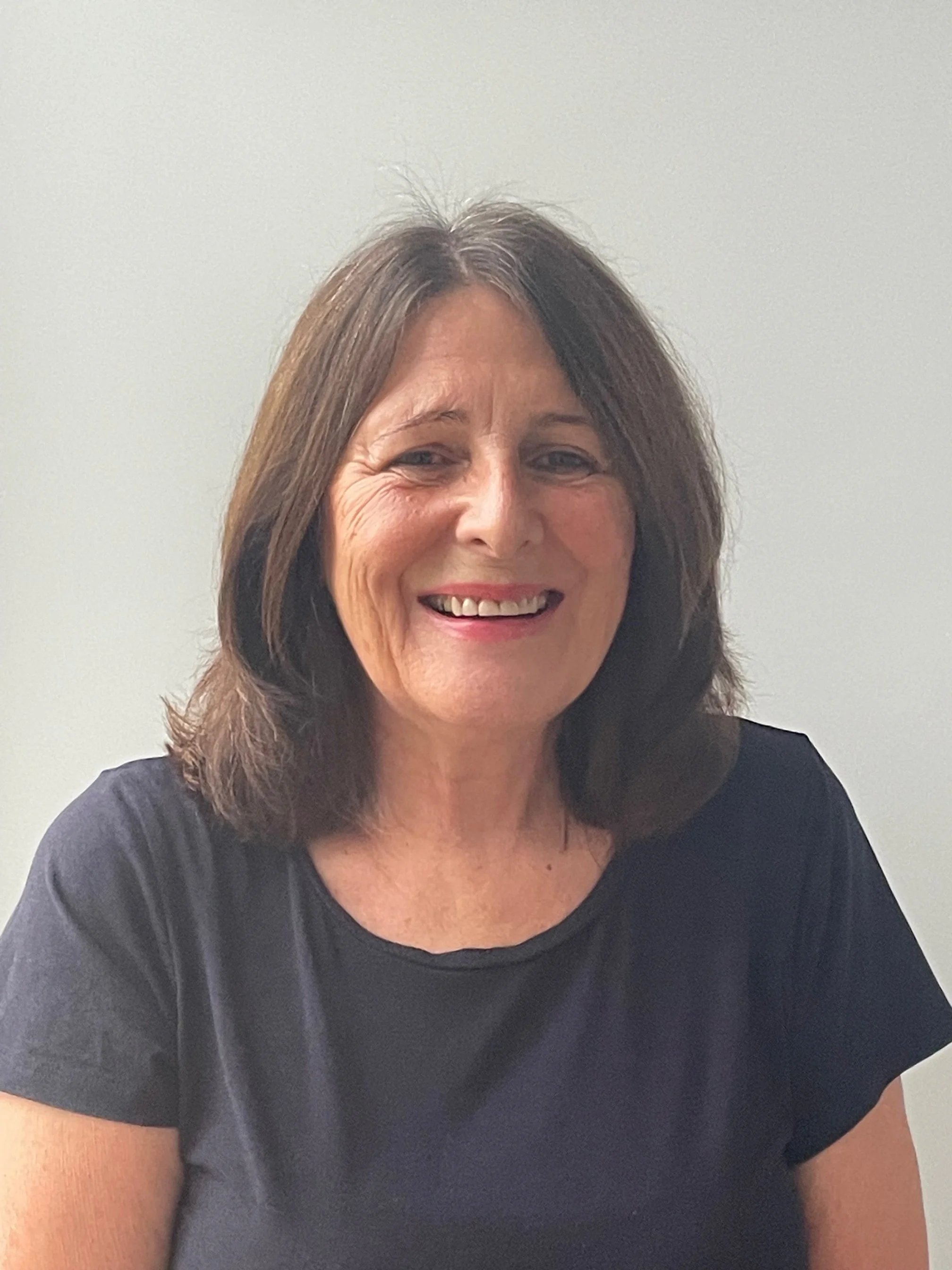 Head and shoulders of Wendy Noel wearing a dark t-shirt in front of a white background