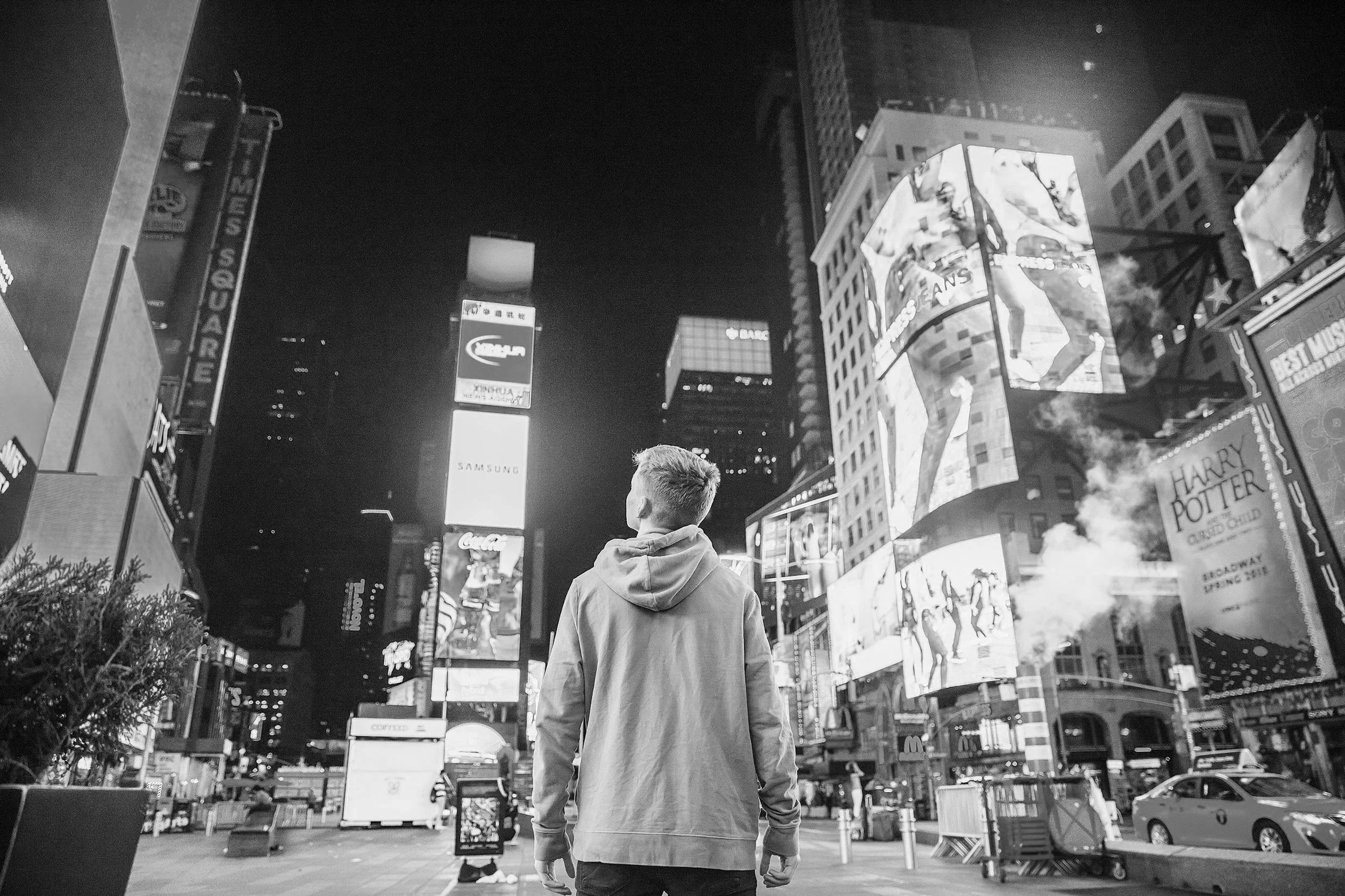 Black and white photo of a person holding a folded US dollar bill.