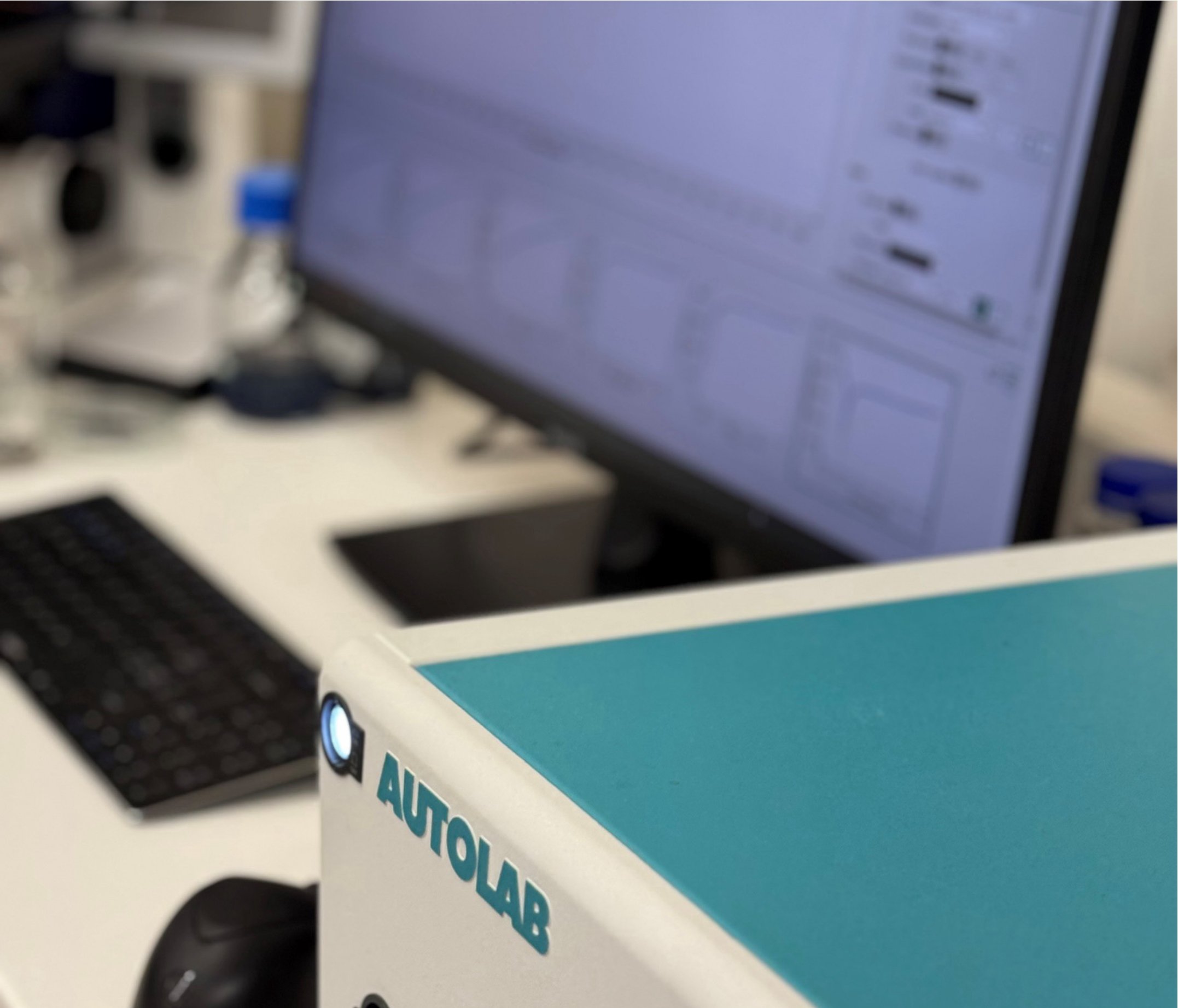 Laborausrüstung und Computer im Labor, Fokus auf das Gerät mit 'AUTOLAB' Aufschrift.