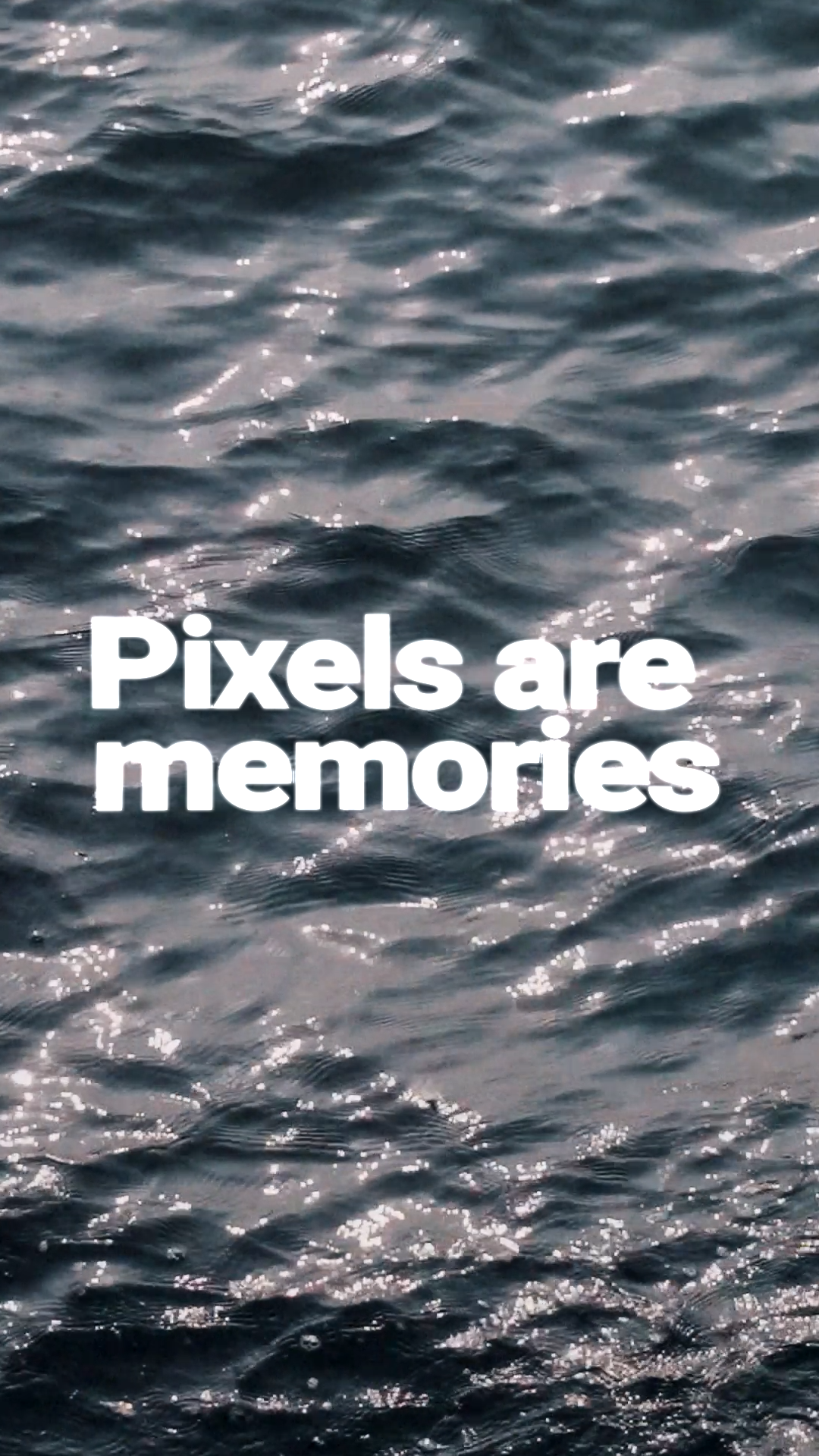 Close-up of ocean water with sunlight reflections and the text 'Pixels are memories' overlayed.