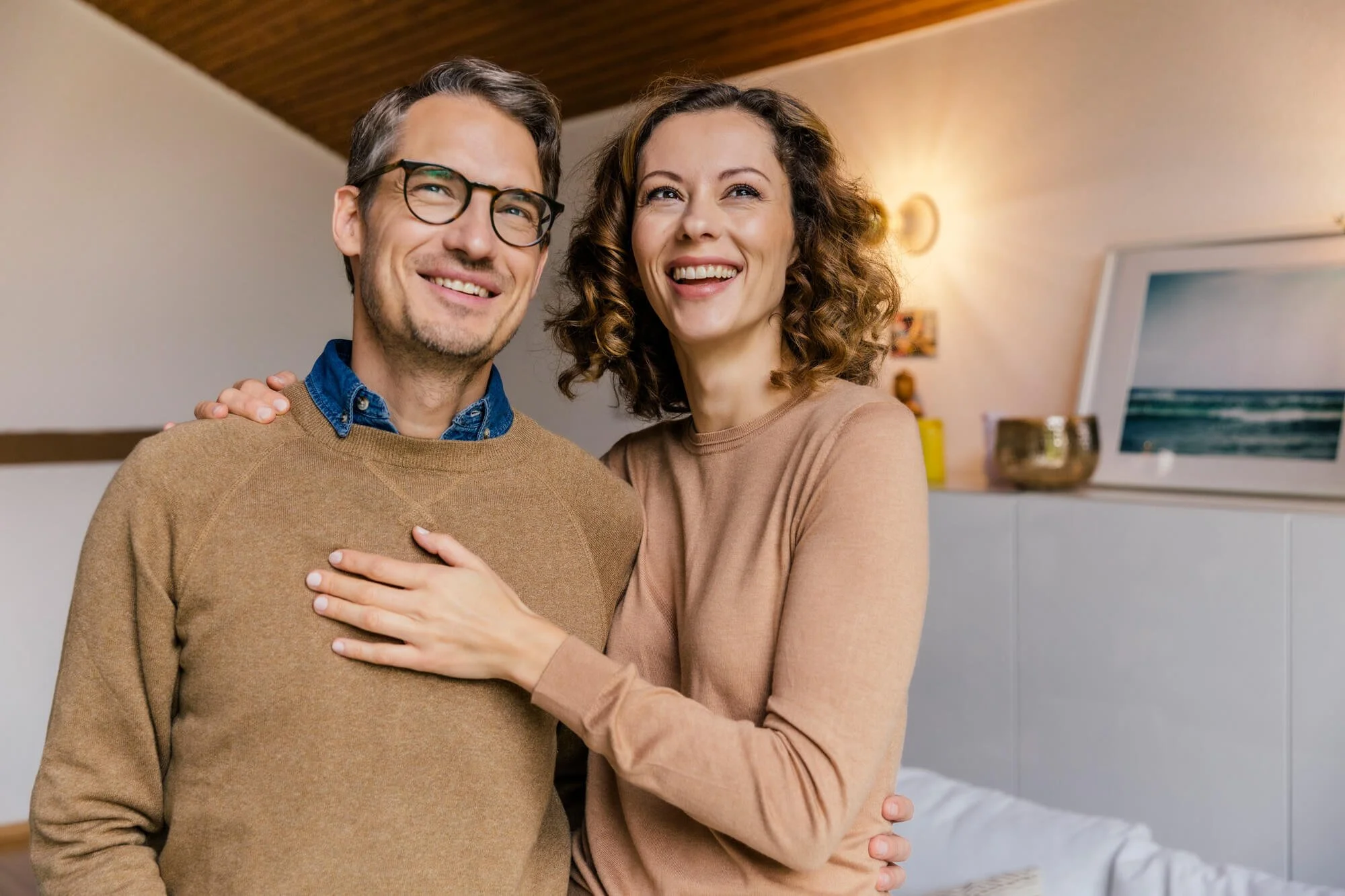 Woman holding her husband around the shoulder
