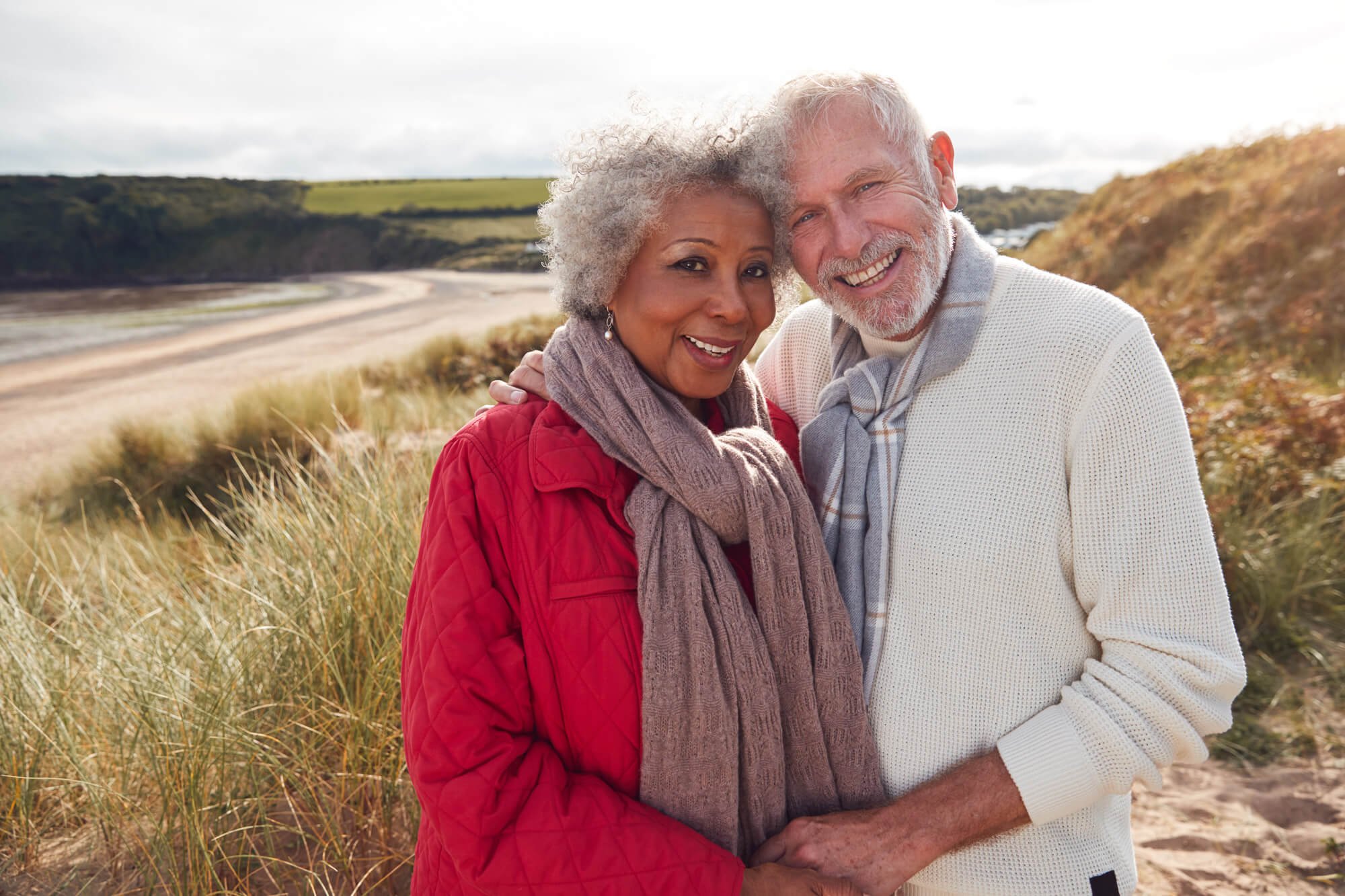 Elderly couple smiling and hugging each other