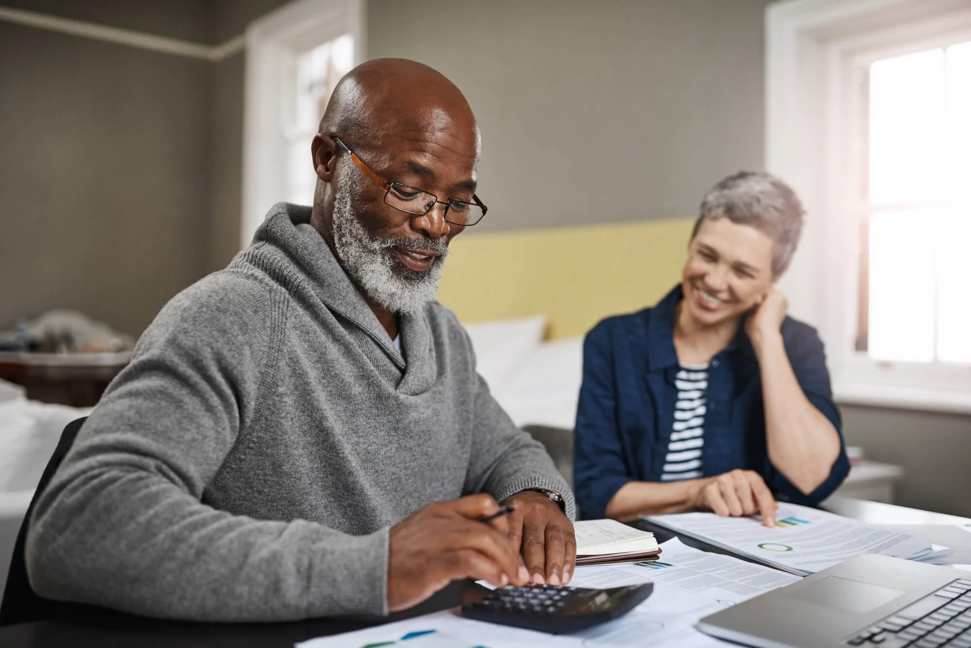 Couple using a calculator with paperwork