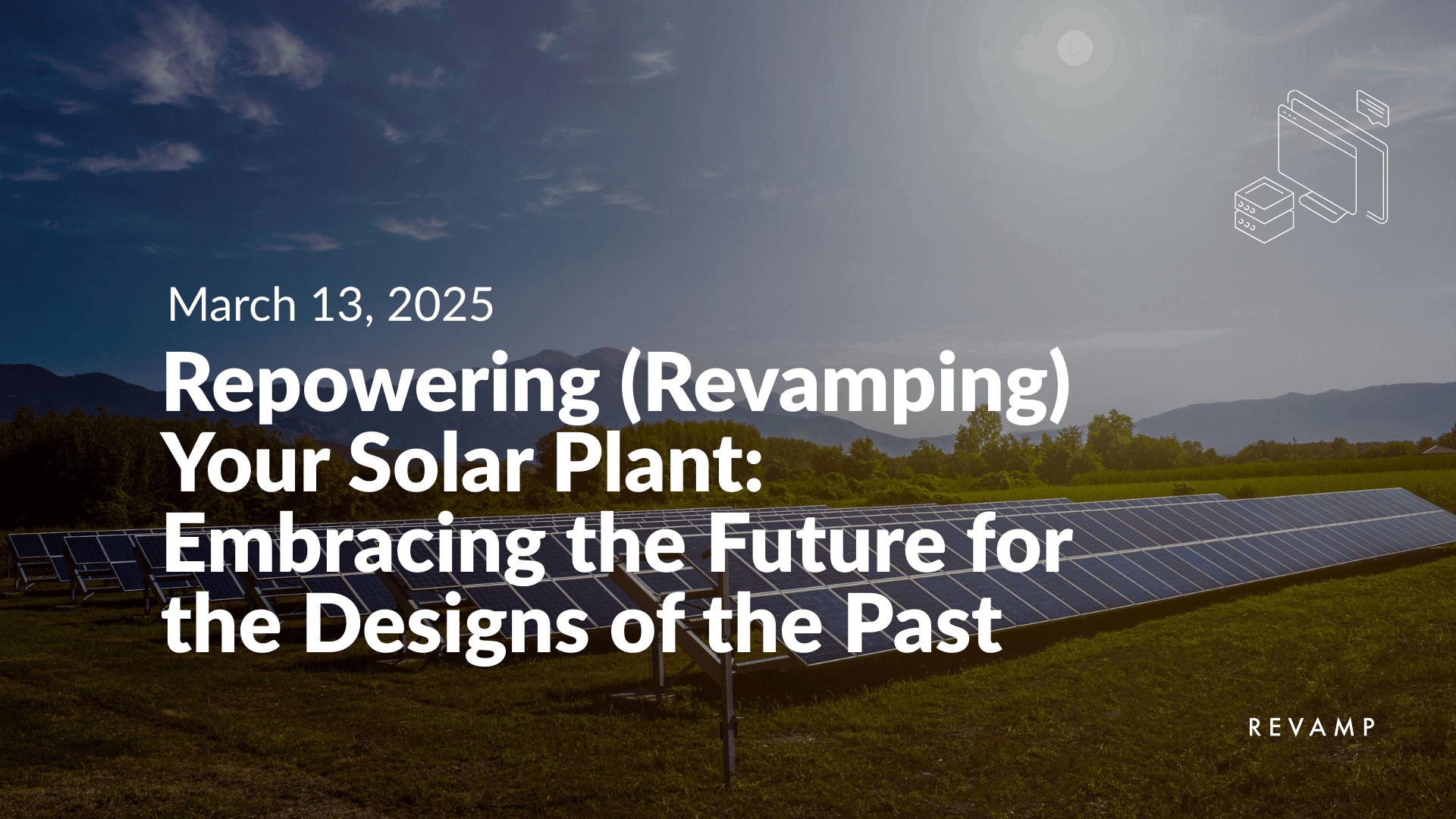 Solar panels installed on a grassy field with mountains and trees in the background under a partly cloudy sky during daytime.