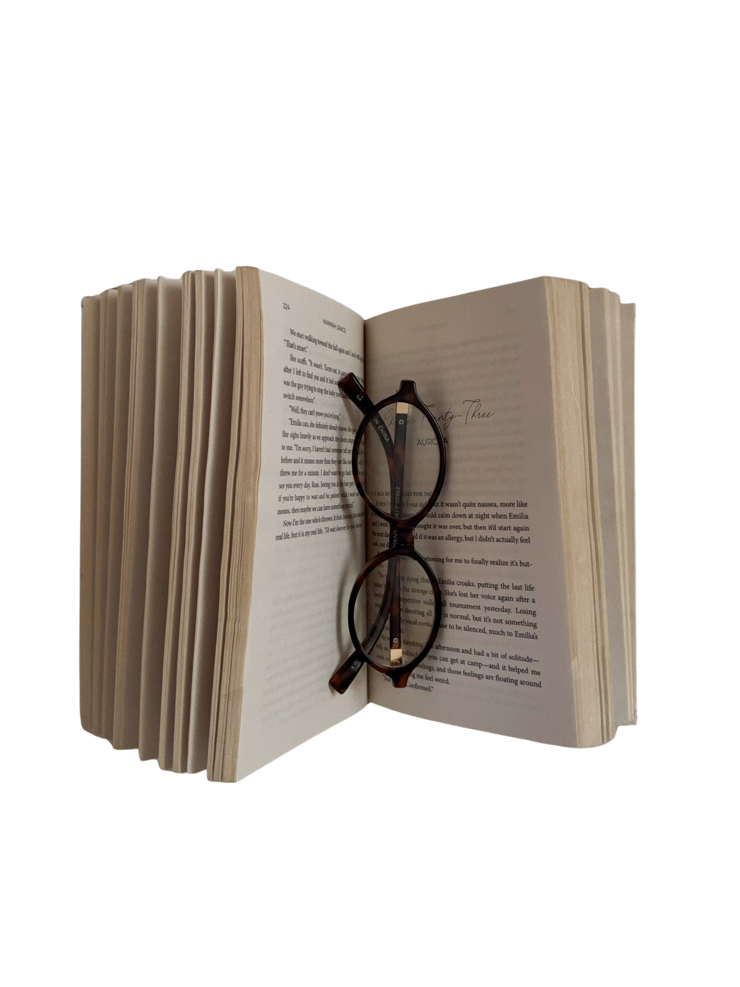 Cozy reading moment with a romance novel and glasses.