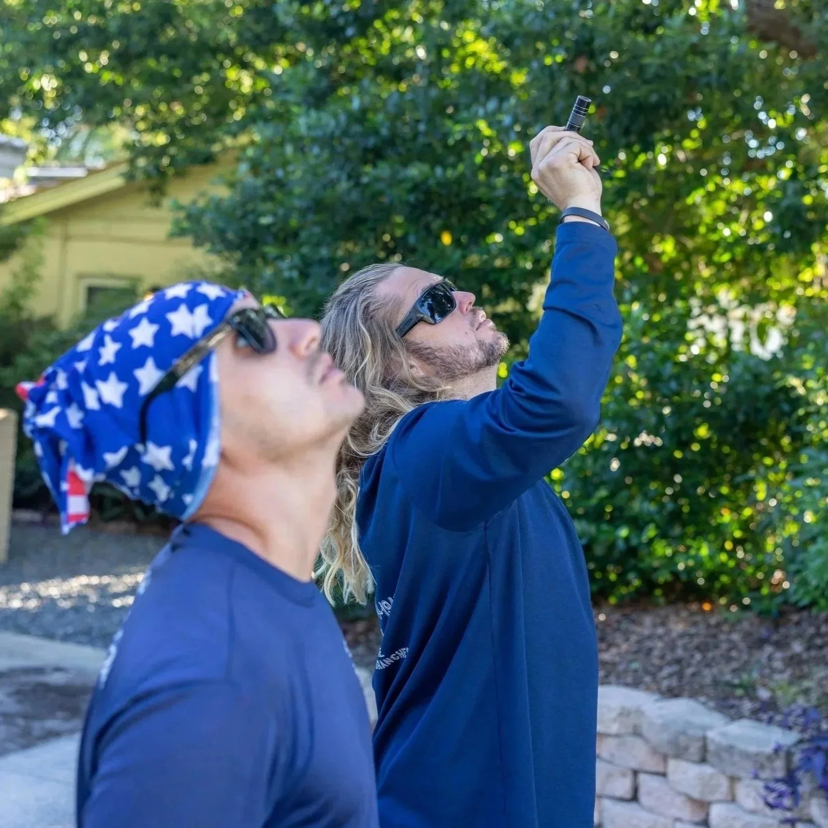 Arborist installing high-strength cables in a large tree canopy to provide structural support and reduce limb failure risk.