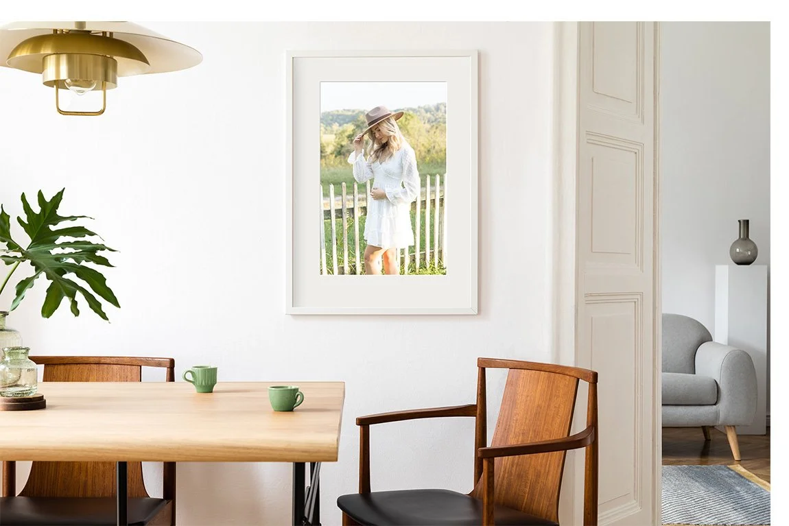 Framed senior portrait displayed in a bright dining room