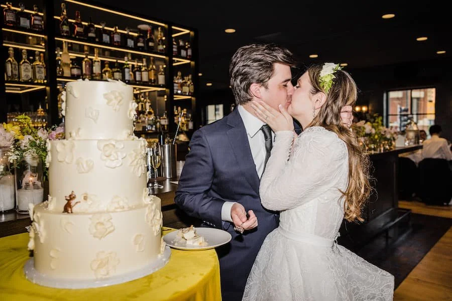 lemon raspberry cake - couple kissing next to a wedding cake