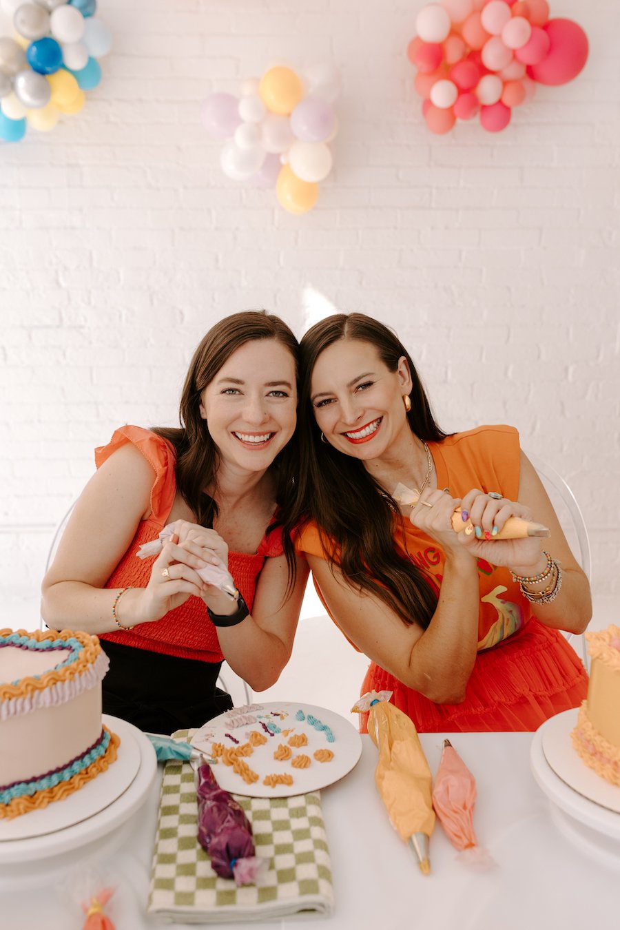 best kitchenaid attachment for frosting - two women holding piping bags