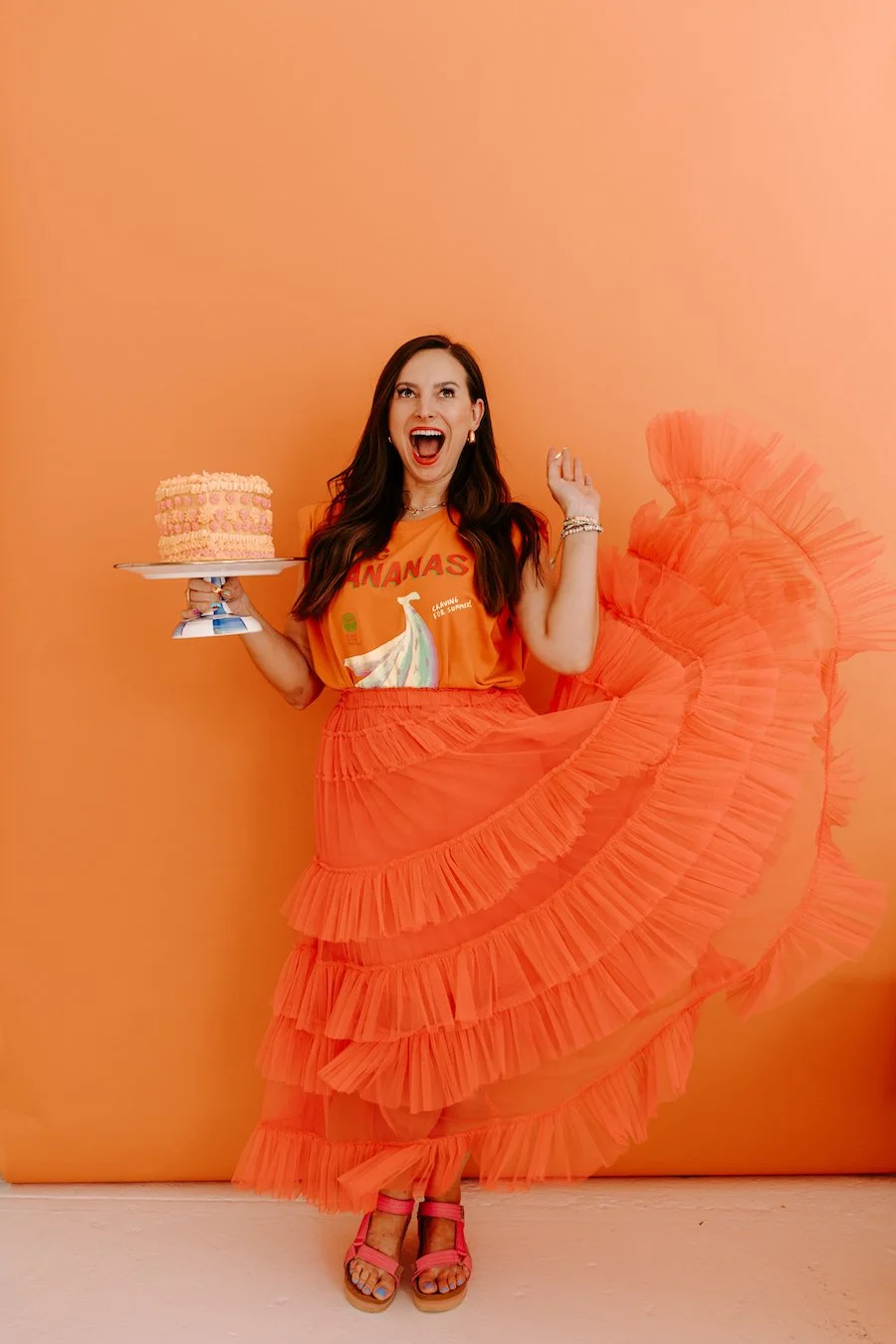 cake decoration accessories - woman standing and holding a decorated cake