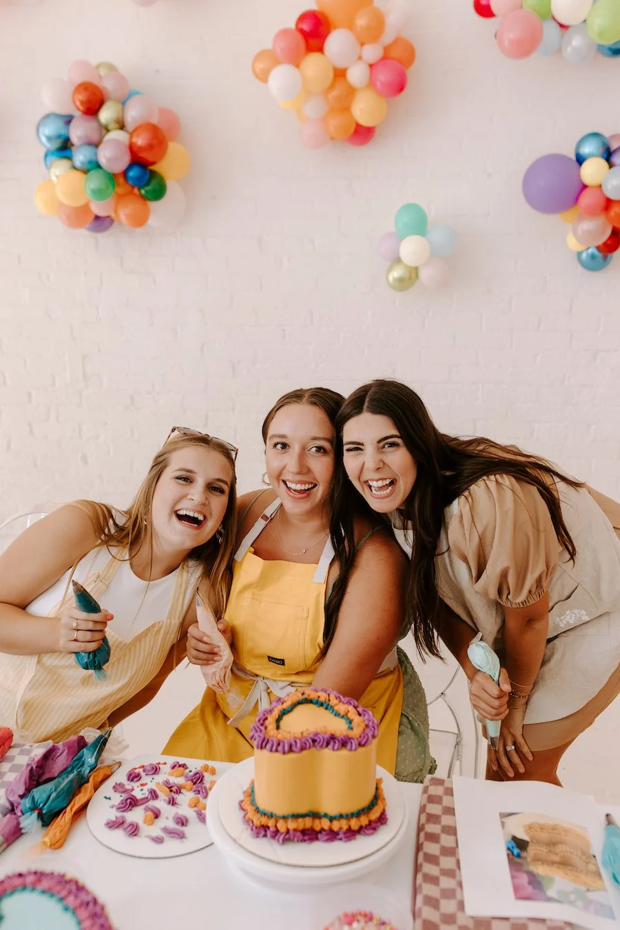 cake decoration accessories - three people posing with a cake