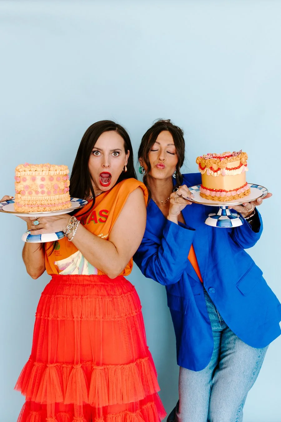 cake frosting types - two people holding decorated cakes