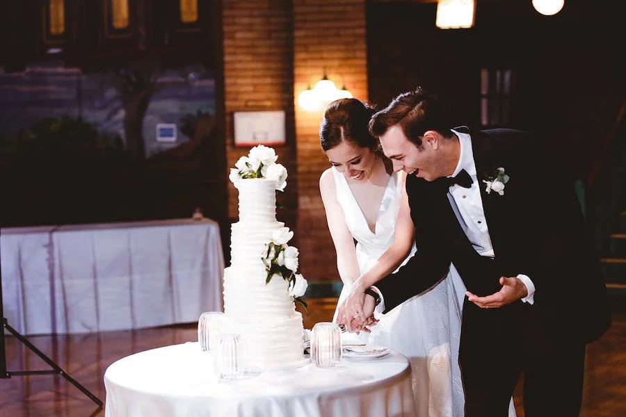 what makes cake dense vs fluffy - couple cutting their wedding cake