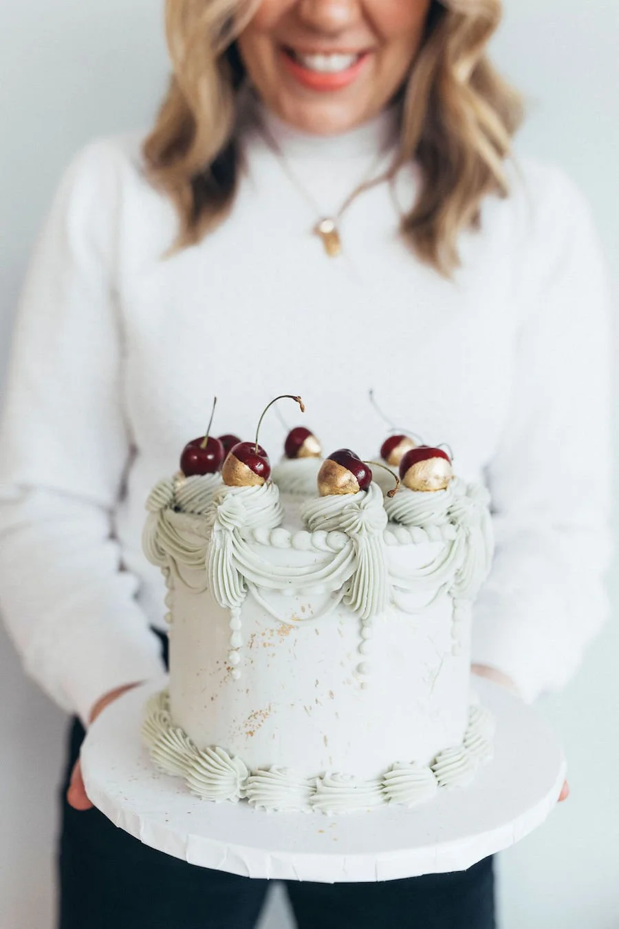 how long is cake safe to eat - woman holding a cake on a cake board