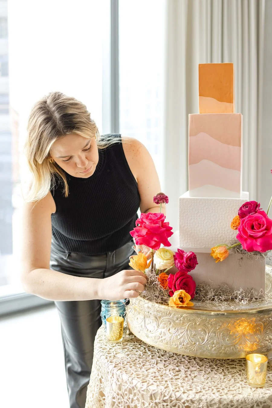 how to tier a cake - Erin putting finishing touches on a cake