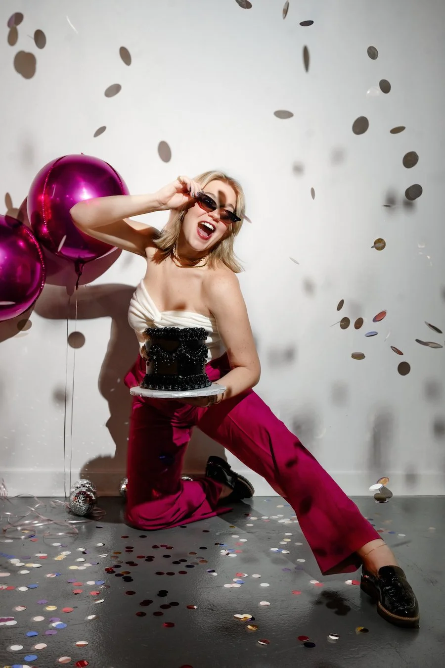 New Year's Eve cake ideas - Erin wearing sunglasses, holding a cake