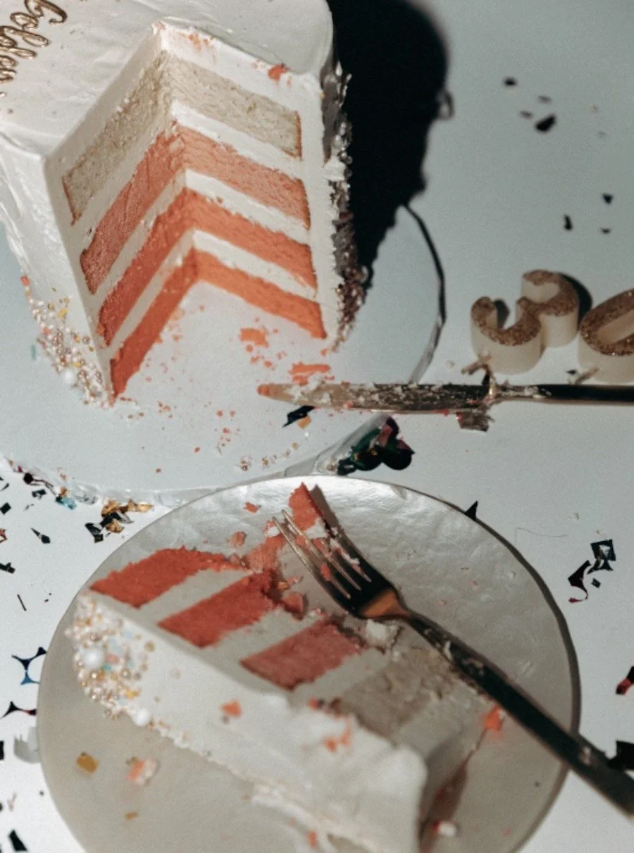 yellow cake vs vanilla cake - layer cake with a slice cut out of it and placed next to it on a plate