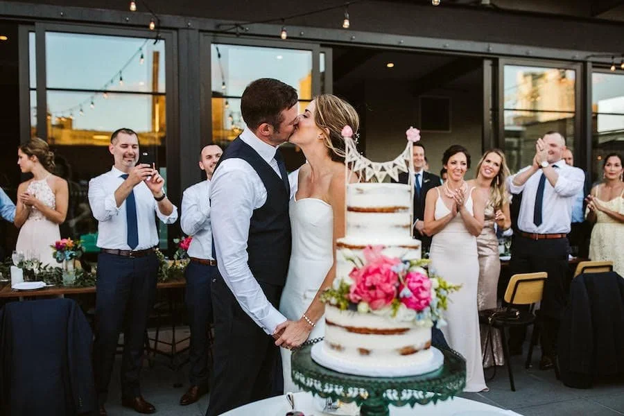 naked cake / naked cakes - couple kissing behind a naked wedding cake
