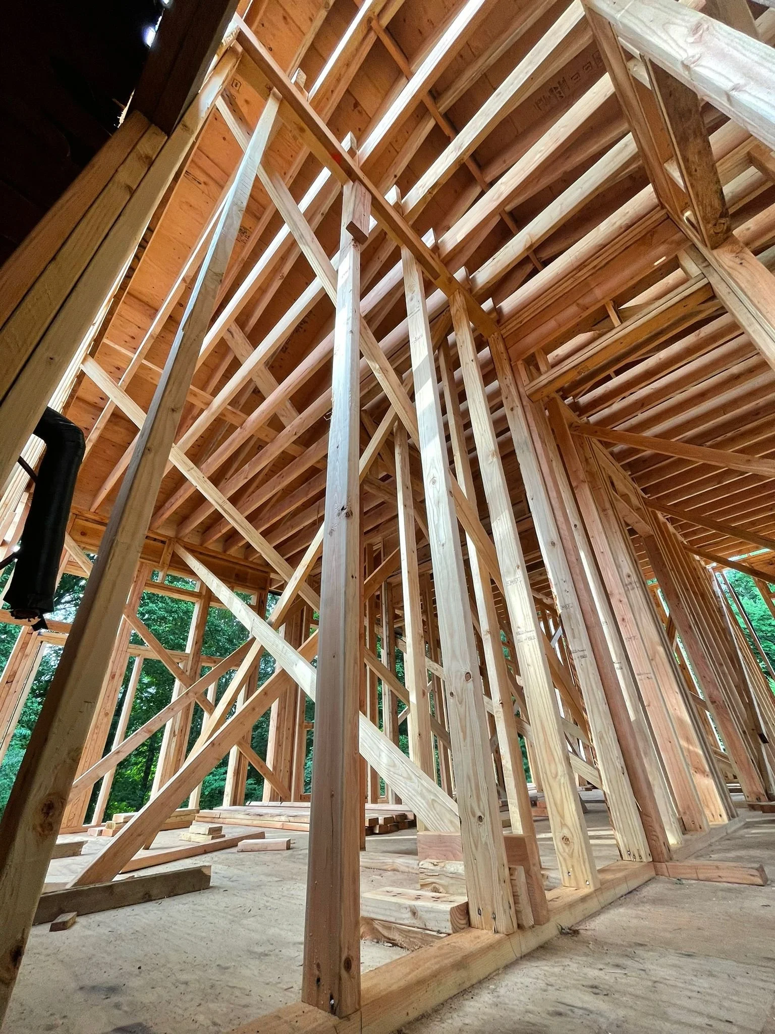 Wooden framing of a building under construction with visible beams and support structures.
