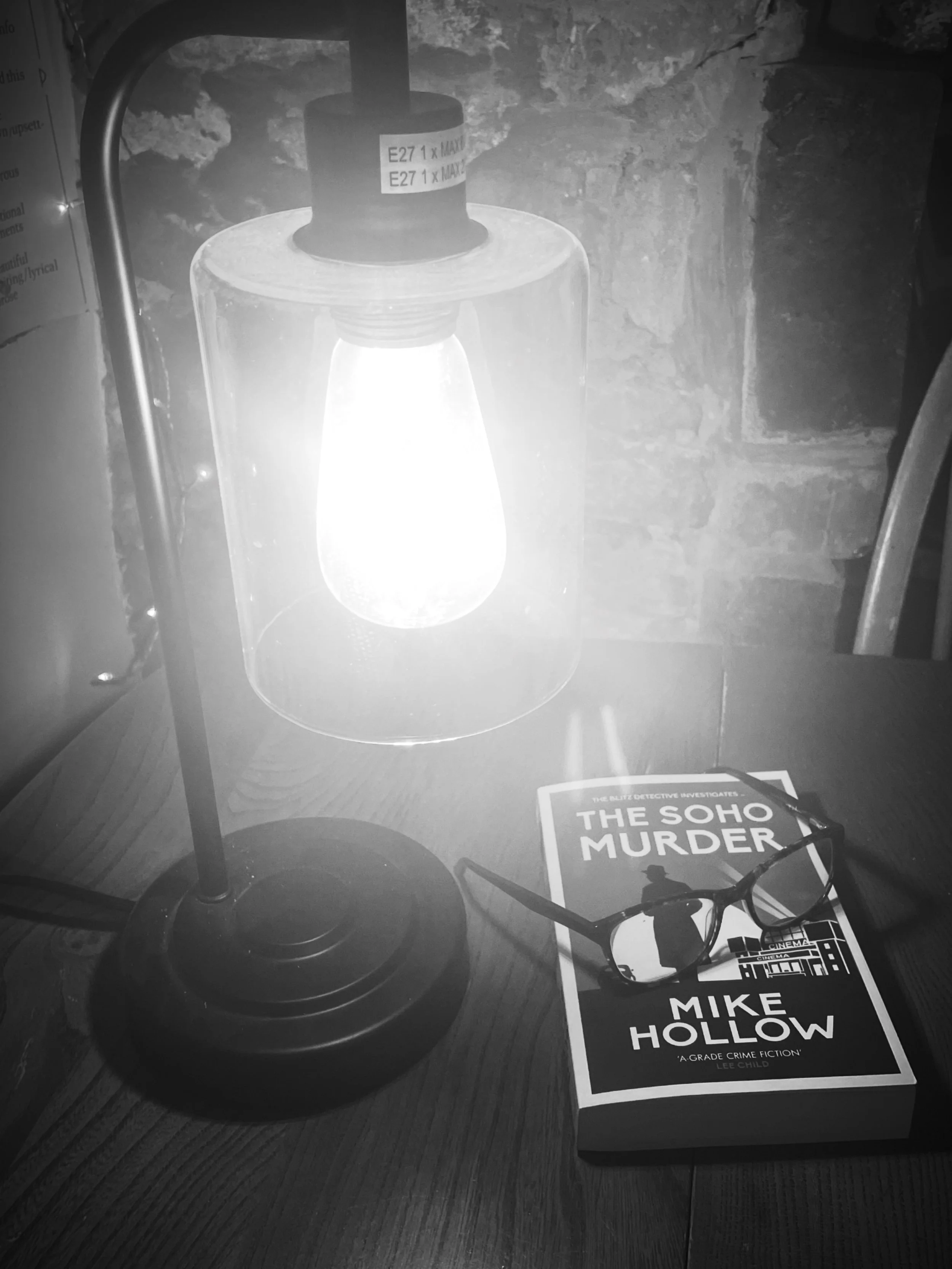 Murder Mystery book, eye glasses under lamplight
