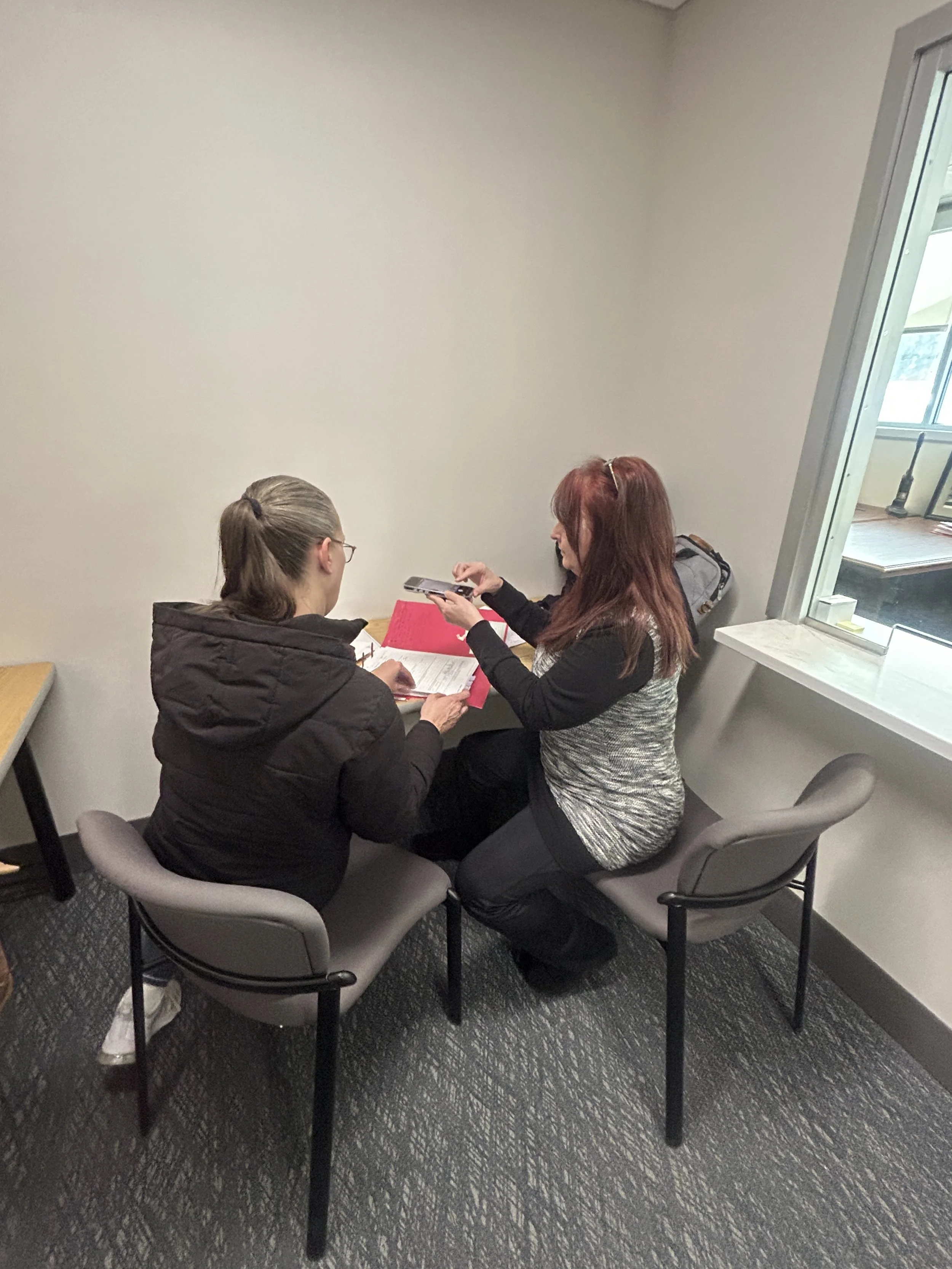 Jody White and Shannon Tannis examining files