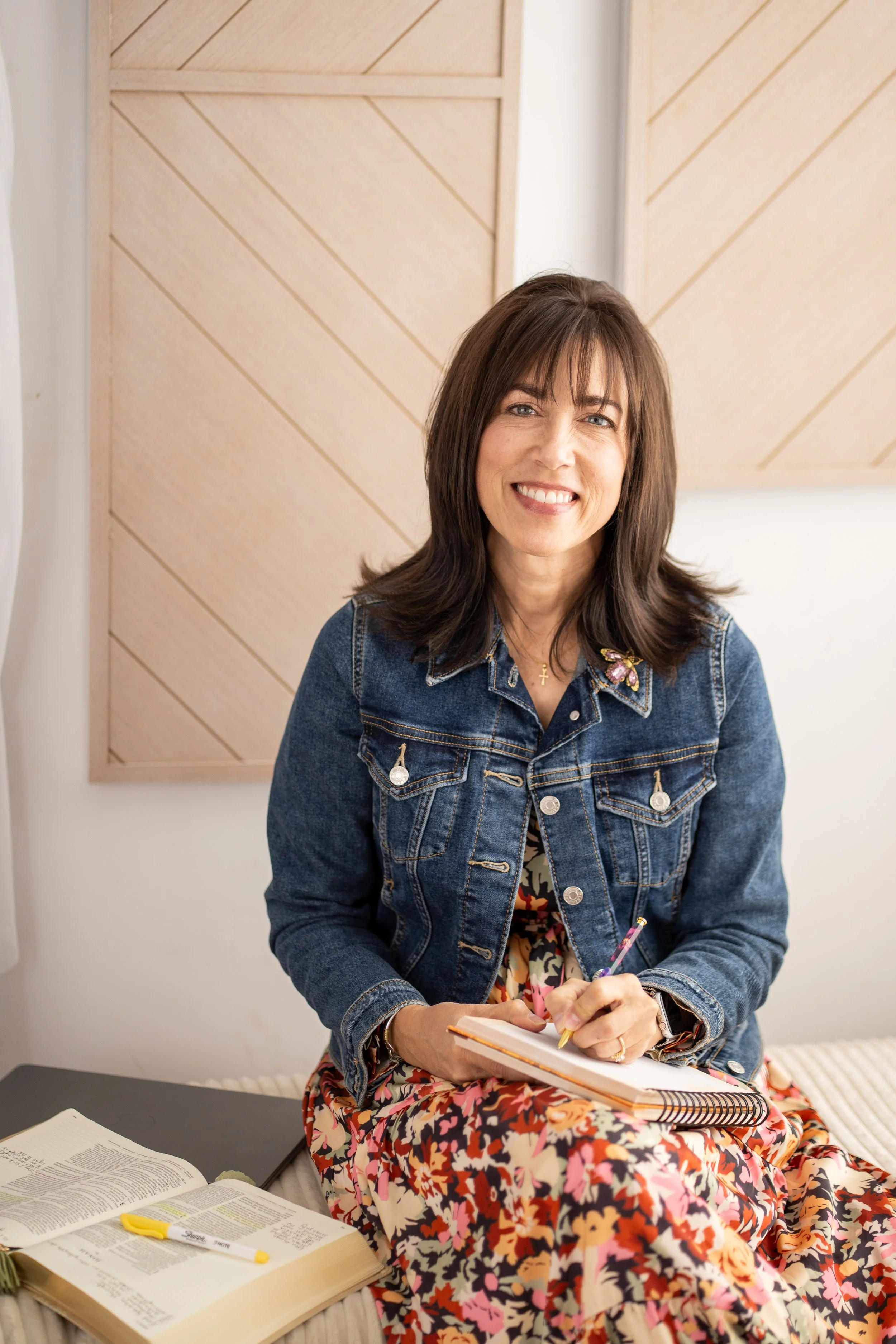 Tracee Blake smiling while sitting, founder of A Place of Belonging and writer of Christian encouragement for women